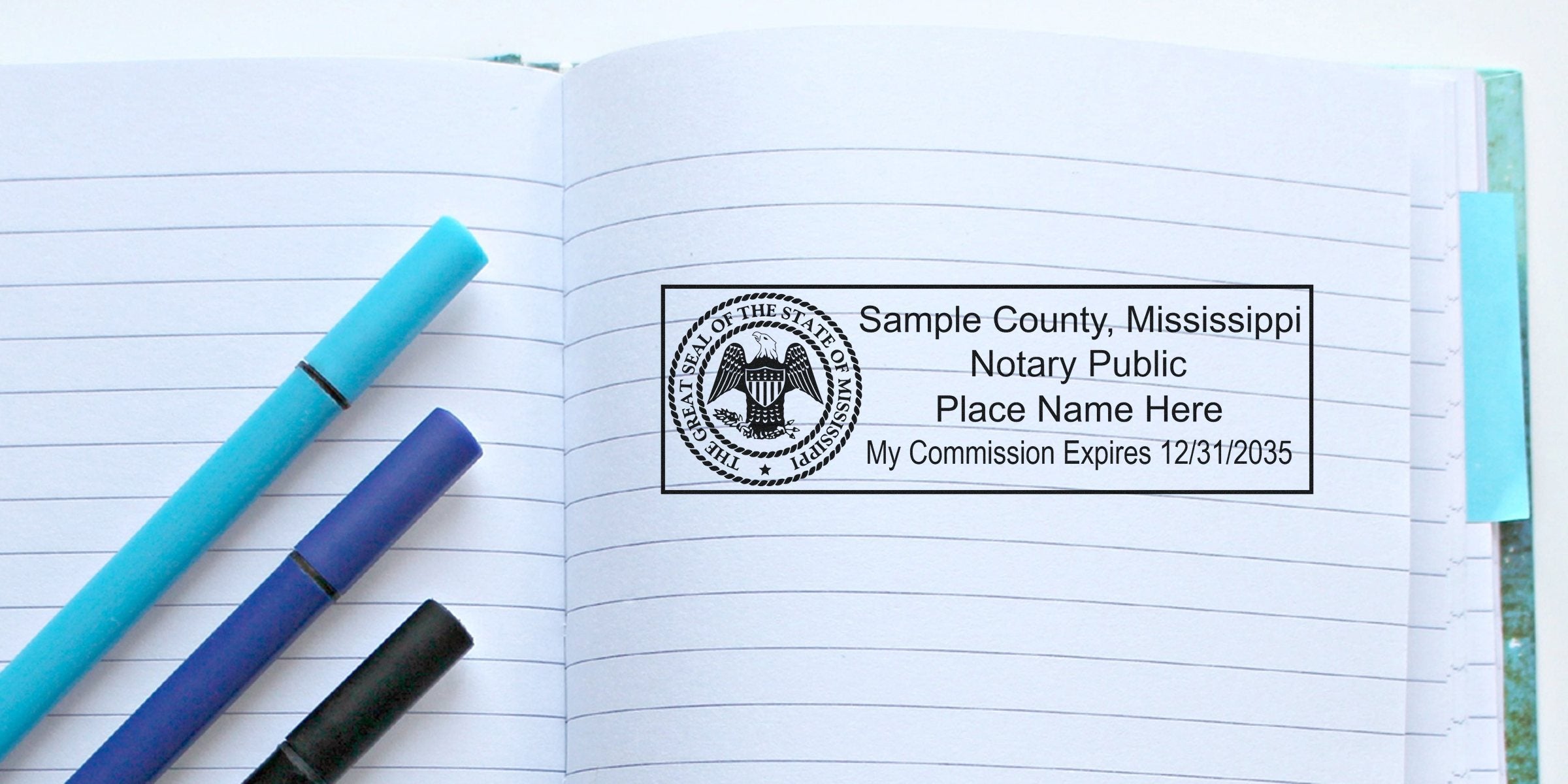Mississippi notary stamp on lined notebook page with blue and black pens, showing how to buy a notary stamp online.
