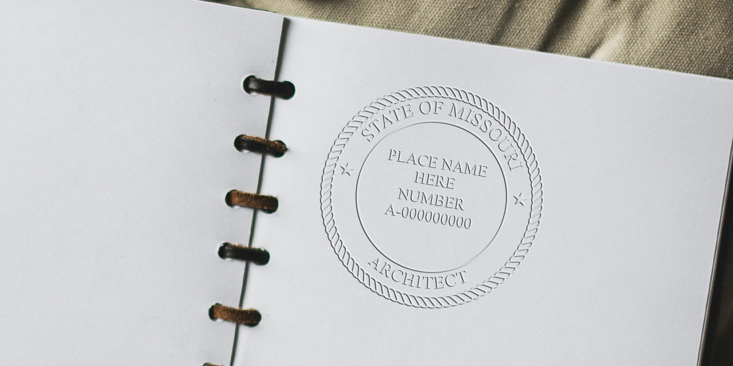 Embossed Missouri architect stamp on white paper with leather notebook background, showing Missouri architect seal and emphasizing online order for architect stamps.