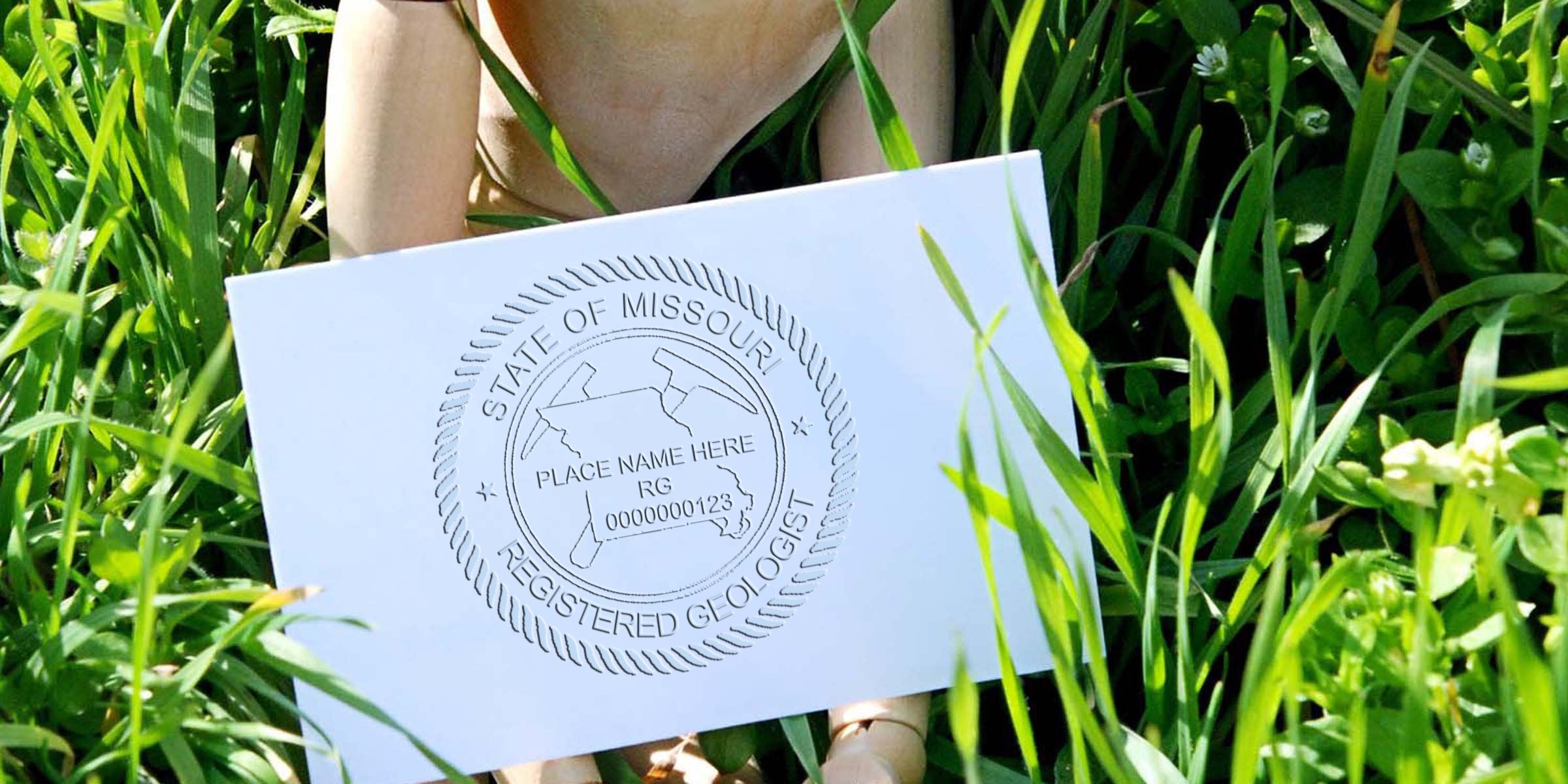 Missouri registered geologist certification card shown in green grass, featuring Missouri geologist stamp and custom seal for professional license verification.