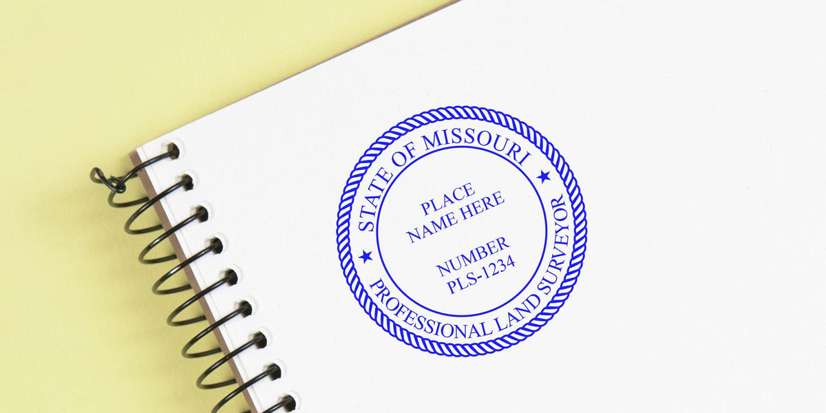 Missouri land surveyor seal stamp on white notebook, perfect for land survey tips and certification.