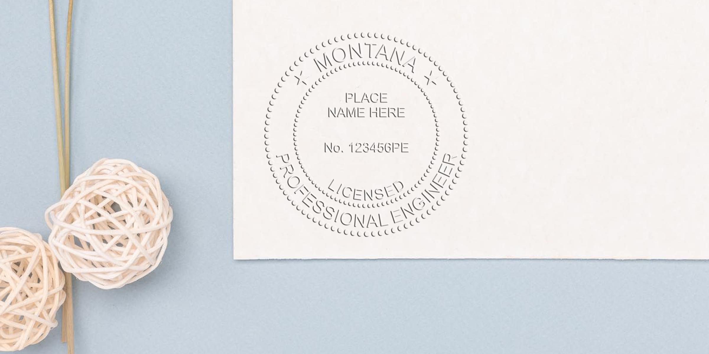 Montana Professional Engineer Seal embossed on white paper with decorative rattan balls on a blue background, highlighting where to buy Engineer Seals online.