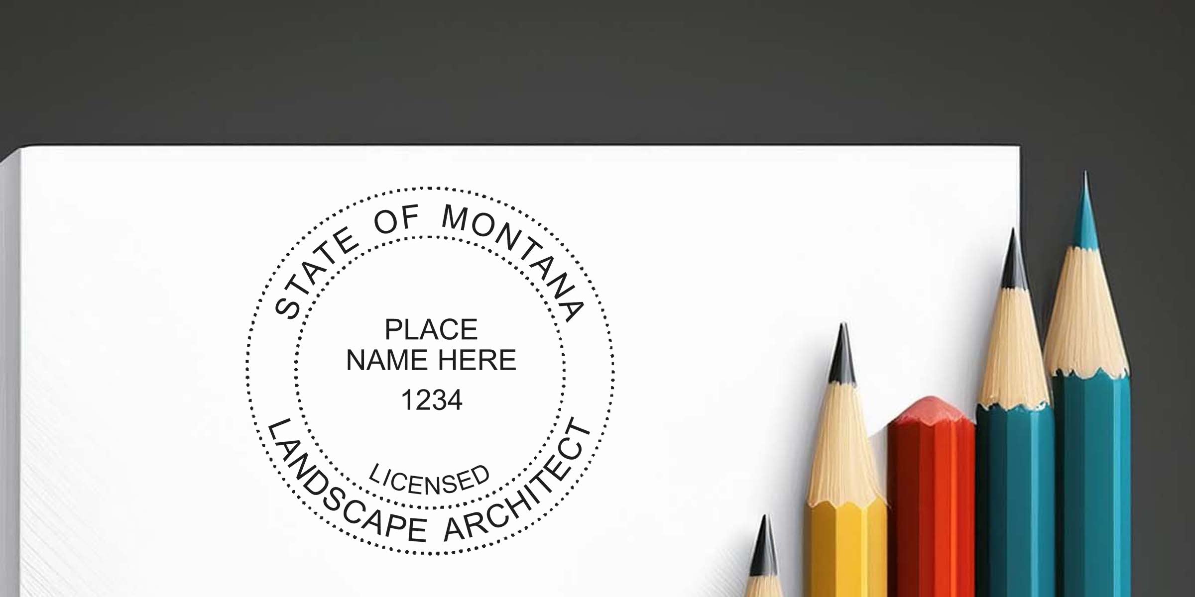 Montana landscape architect’s custom stamp on white paper, surrounded by colored pencils.