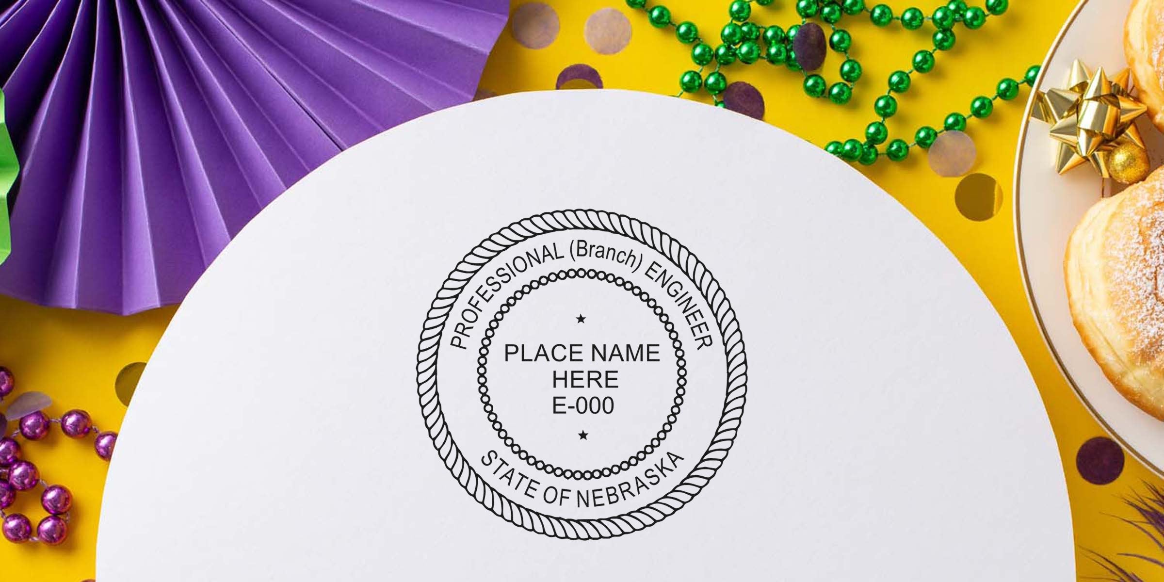 Nebraska engineer stamp embossed on white paper with Mardi Gras decorations and donuts on a yellow background, showing a professional engineer seal and stamp embosser.