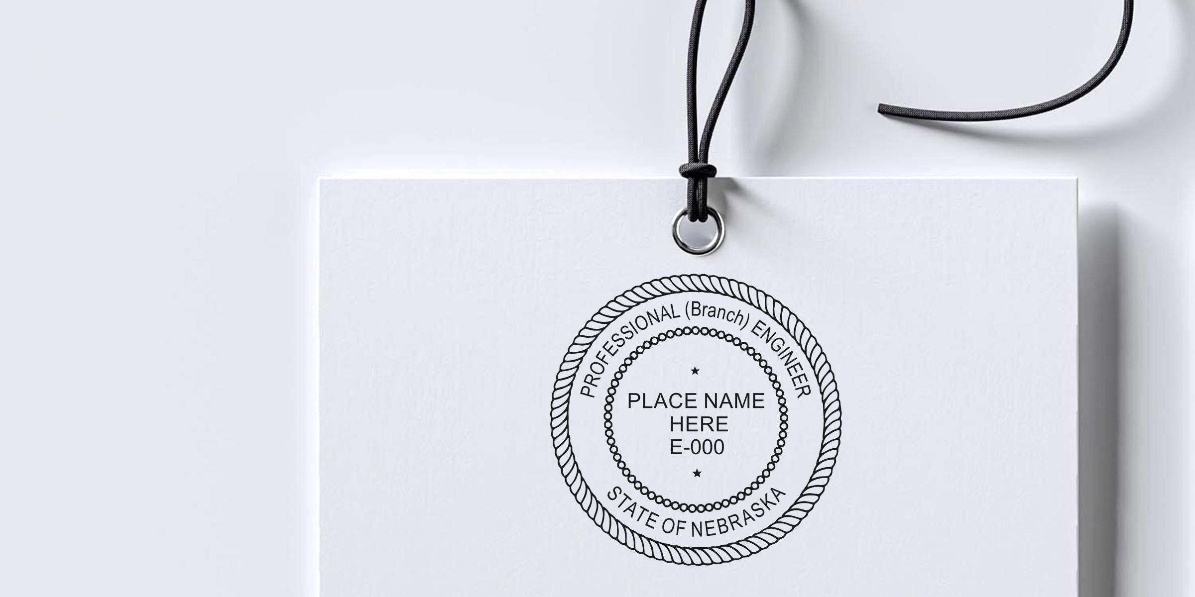 Nebraska pro engineer seal on white tag with black string, customizable place name and license number, compliant with Nebraska engineering stamp laws and PE stamp requirements.