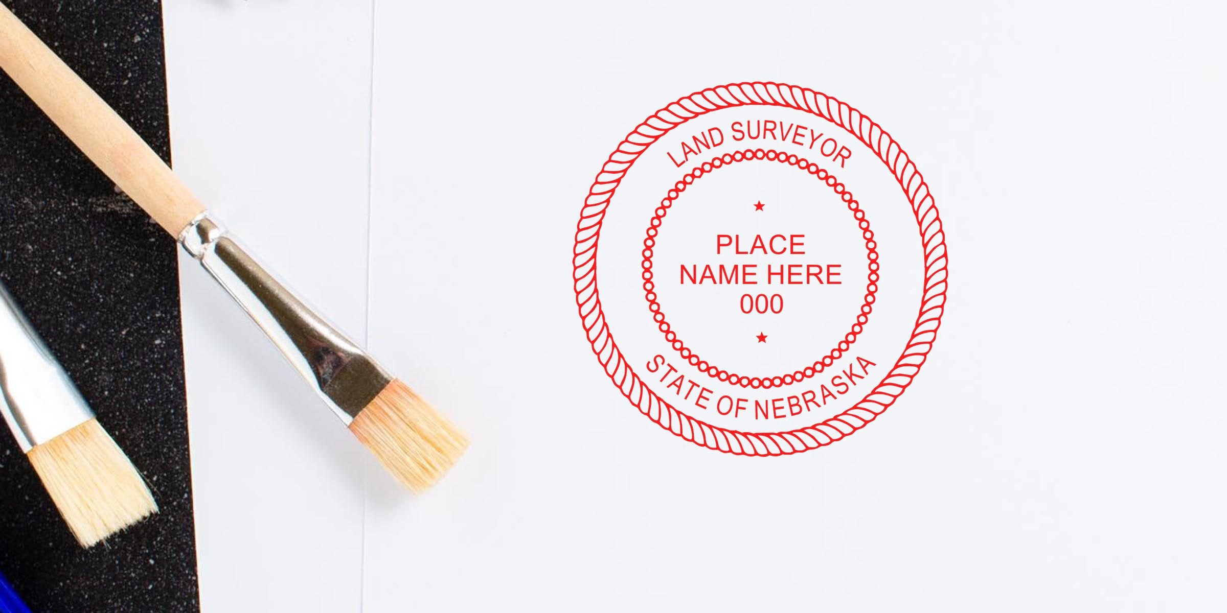 Custom red Nebraska Surveyor Seal stamp on white paper with paintbrushes nearby, meeting Nebraska Surveyor Seal requirements.
