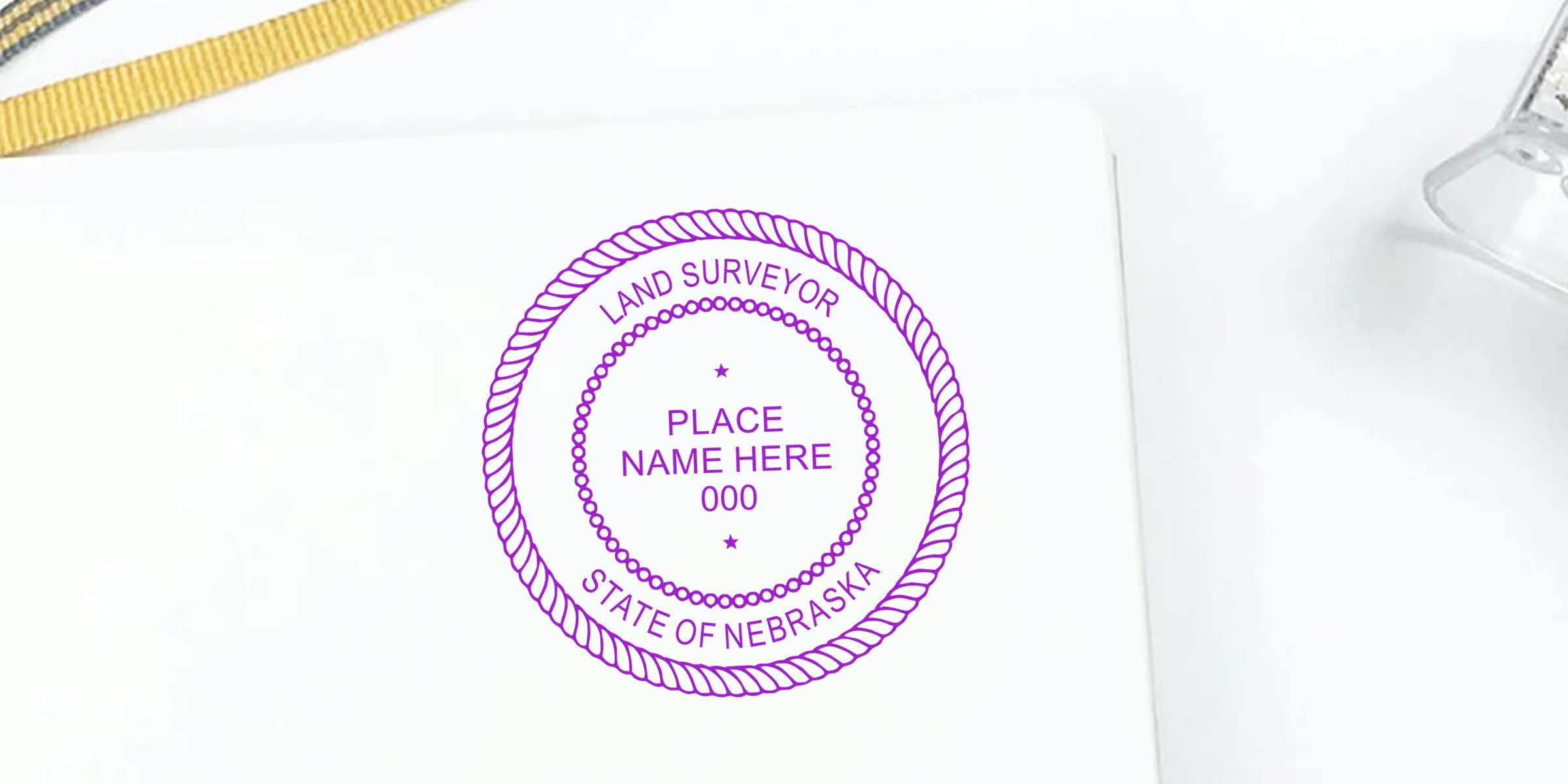 Nebraska land surveyor stamp and embosser with customizable place name and registration number on white background.
