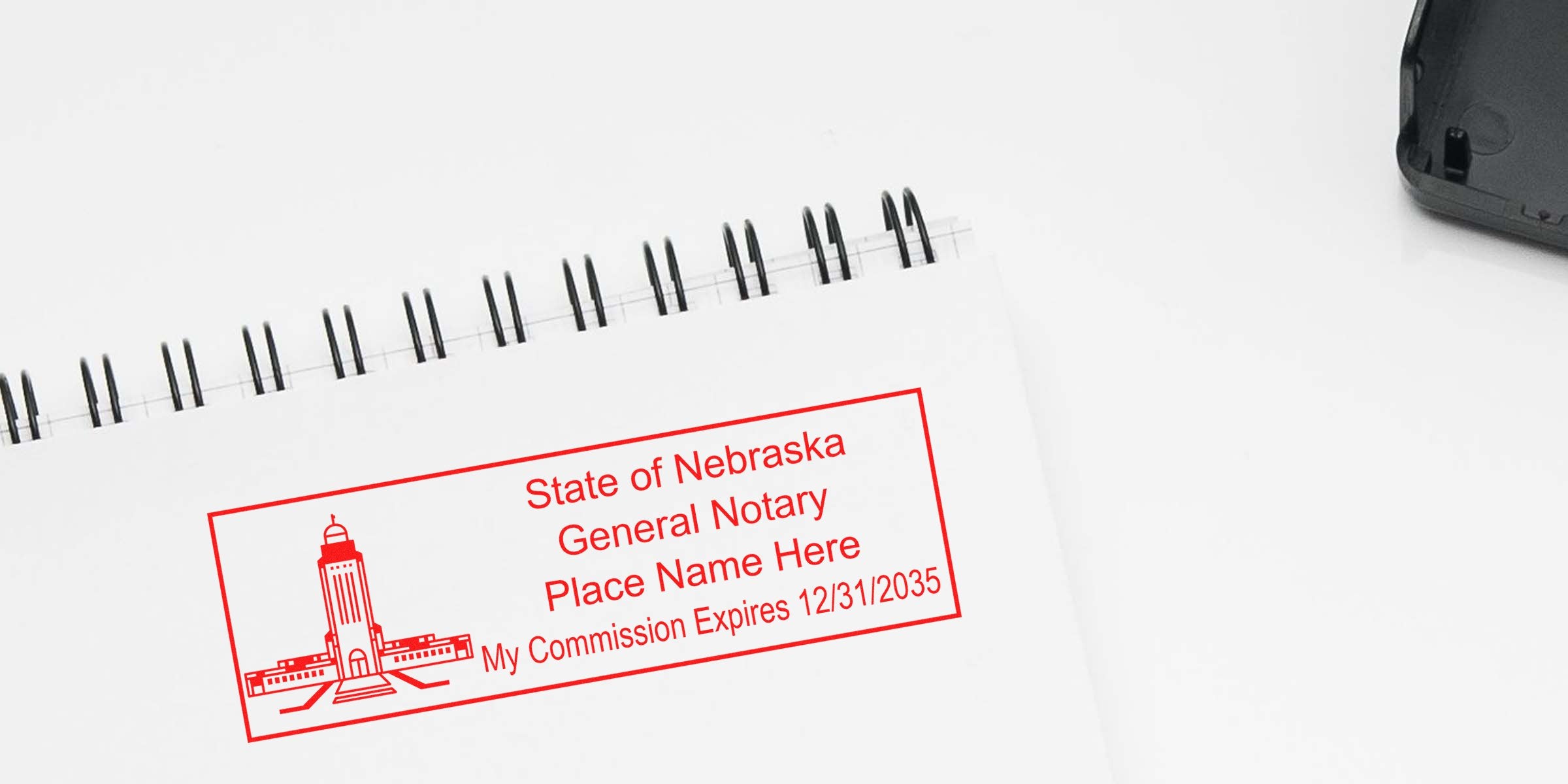 Nebraska notary seal on white spiral notebook showing general notary commission expiration date, featured in a notary stamp guide.