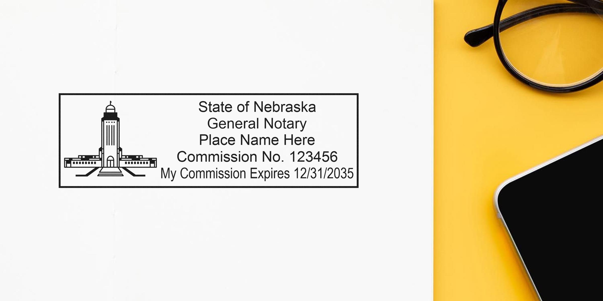 Nebraska notary seal with commission number and expiration date on white paper next to black glasses and smartphone on yellow background, meeting Nebraska notary seal requirements.