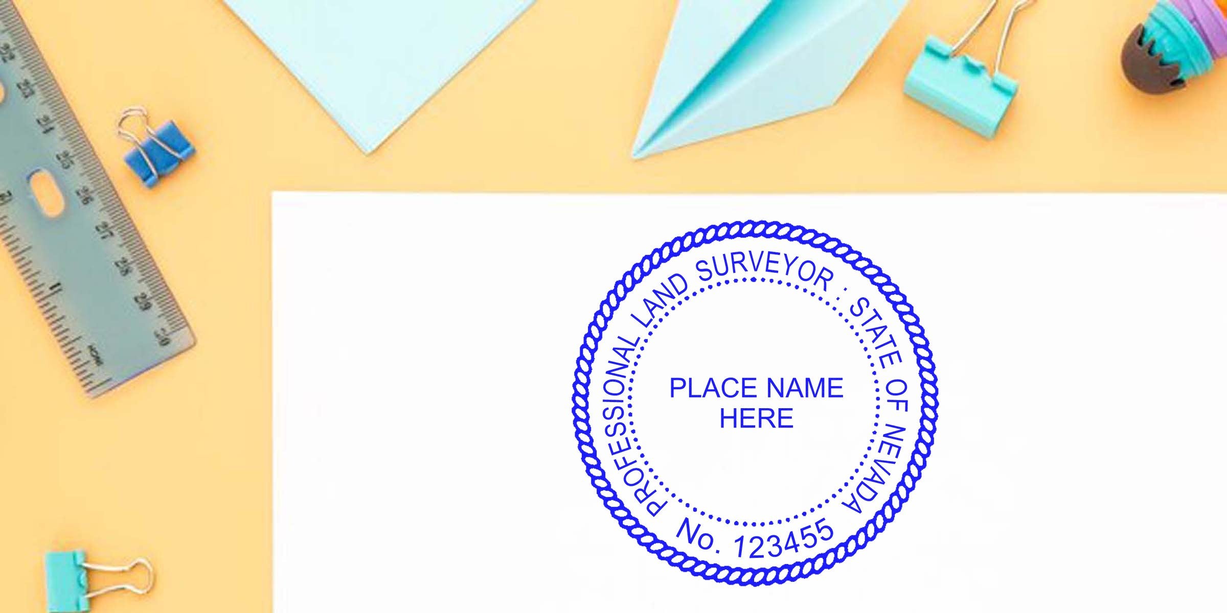 Nevada land surveyor stamp with office supplies on a yellow background, meeting all land surveyor stamp requirements.