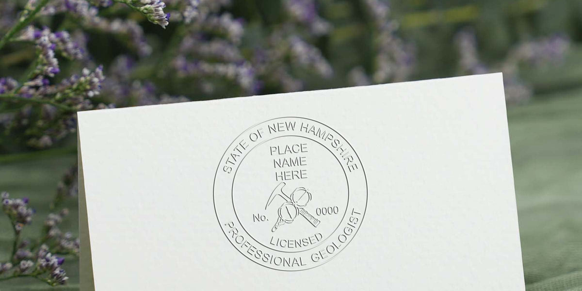 Embossed New Hampshire Geologist Stamp on white paper with a professional license seal and geological tools illustration, part of the Geologist Stamp Guide.