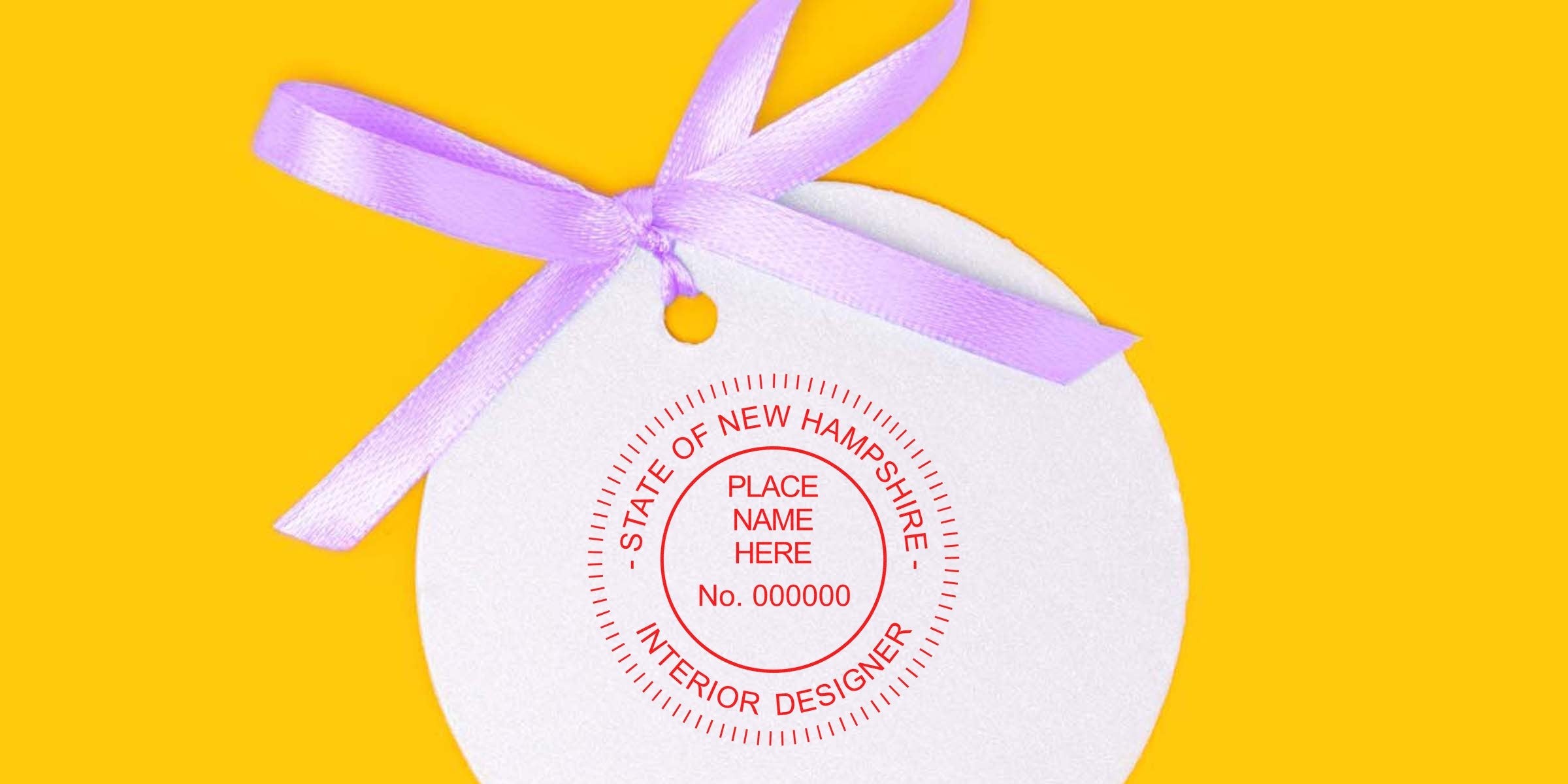 White round gift tag with purple ribbon, showing New Hampshire interior designer stamp on yellow background—ideal for selecting an interior designer.