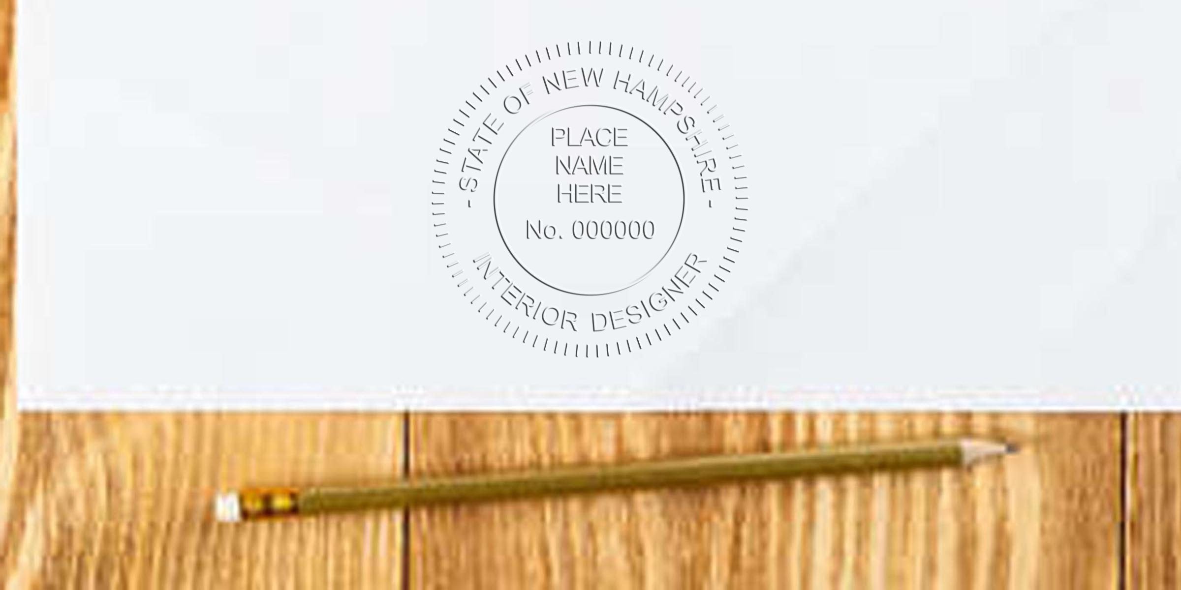 Official seal of New Hampshire interior designer on white paper with pencil on wooden table, showing design guidelines and stamp rules.