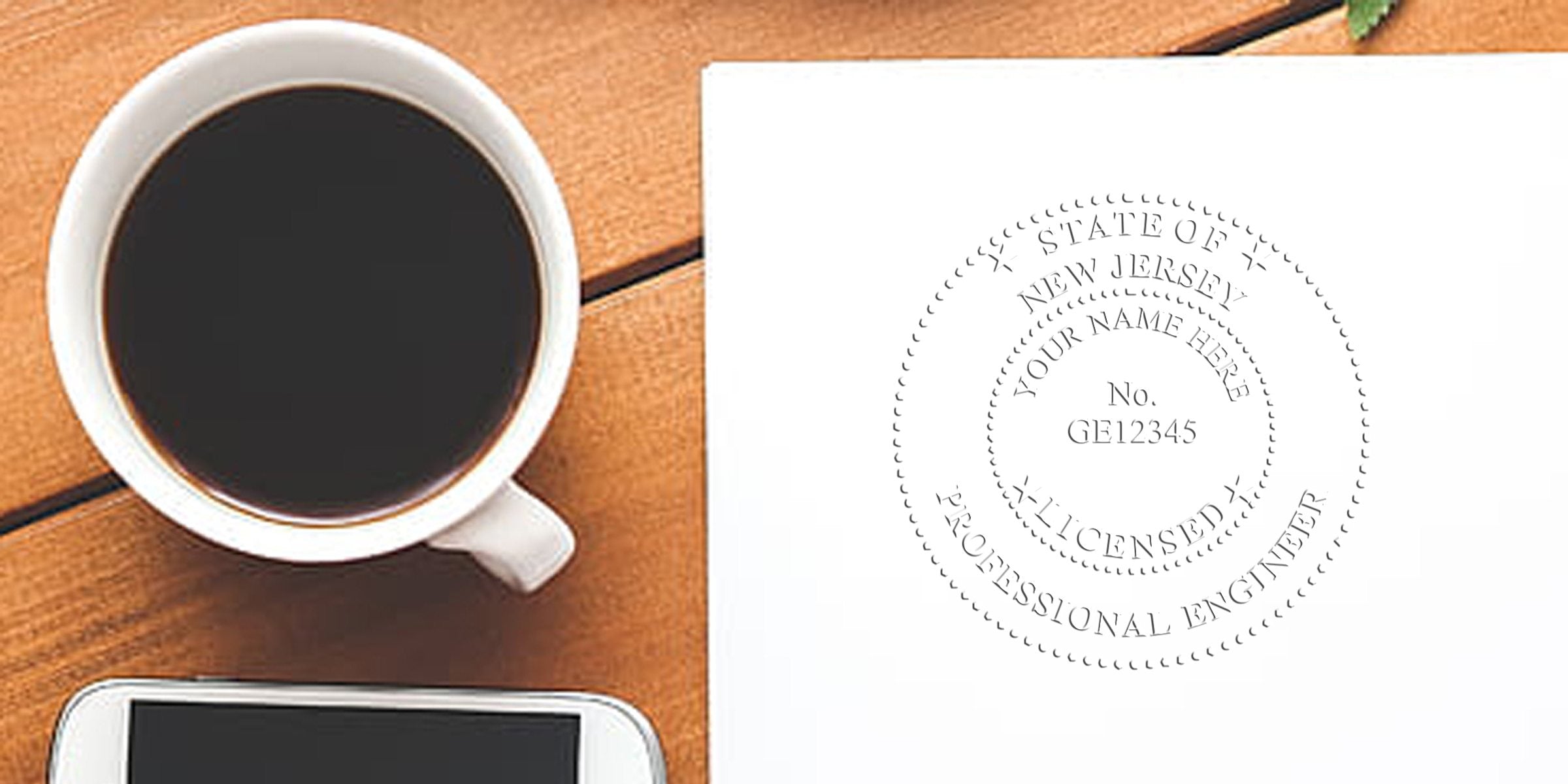 Black coffee cup next to a New Jersey Professional Engineer Seal on white paper, with a smartphone on a wooden table, showing the Online PE Seal New Jersey.