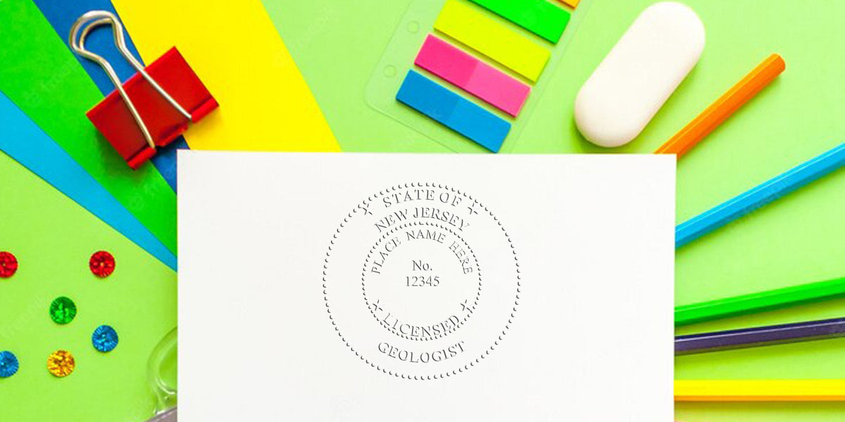 Geologist Seal New Jersey on white paper, surrounded by colorful office supplies, showcasing Professional Geologist Certification NJ.