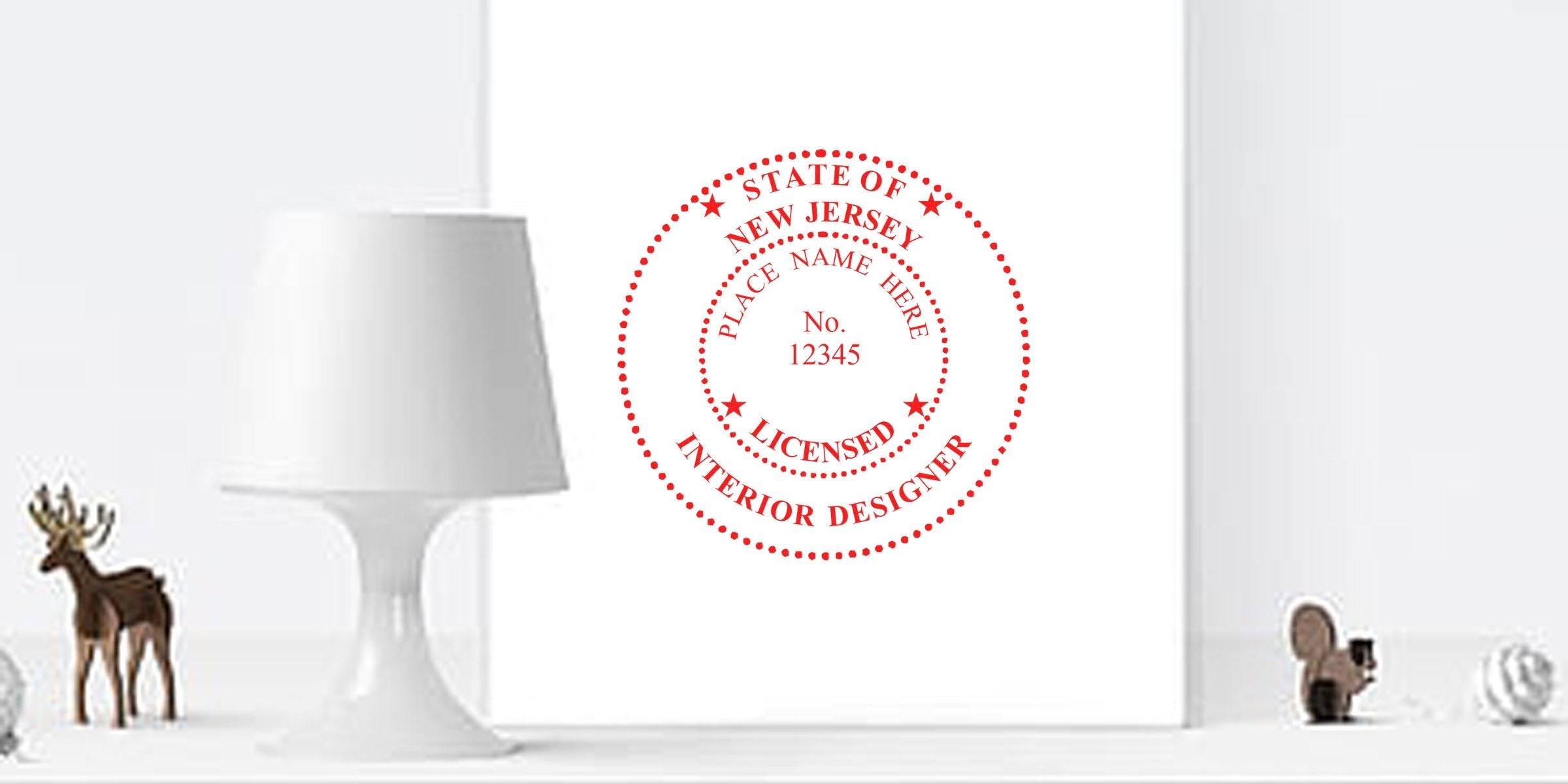Official Interior Designer Seal of New Jersey on white wall, accompanied by a modern lamp and decorative figurines.