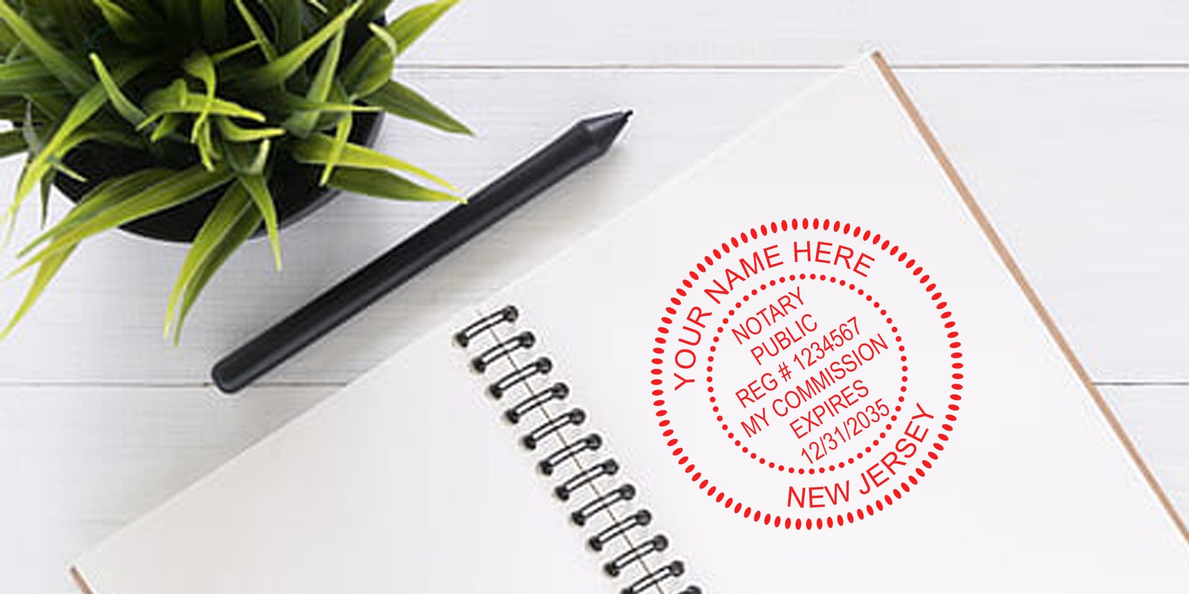 New Jersey notary stamp on notebook with pen and plant on white wooden desk showing NJ notary public seal.