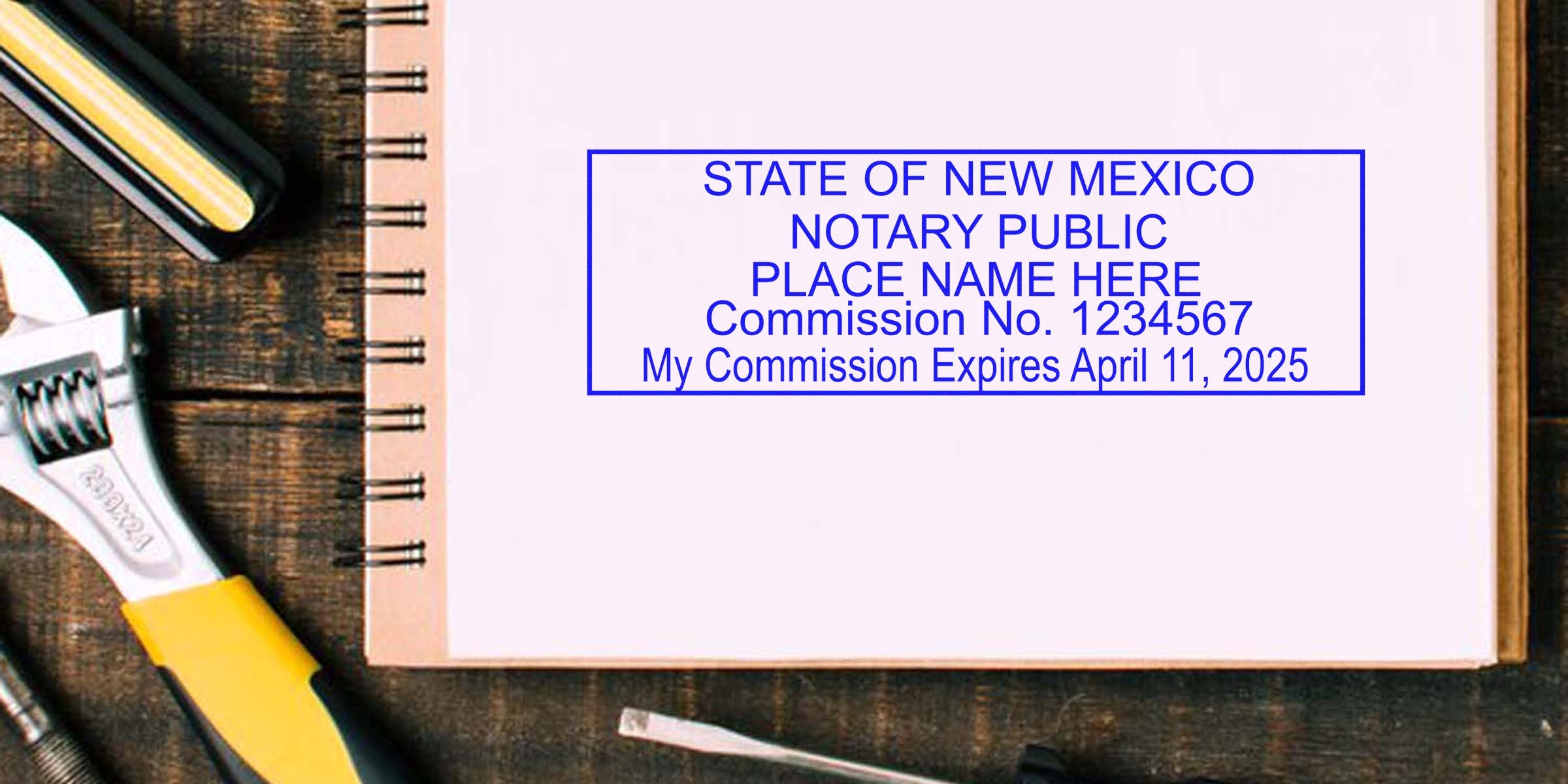 New Mexico notary stamp on a notebook with wrench and screwdriver, showing where to buy notary stamps online.