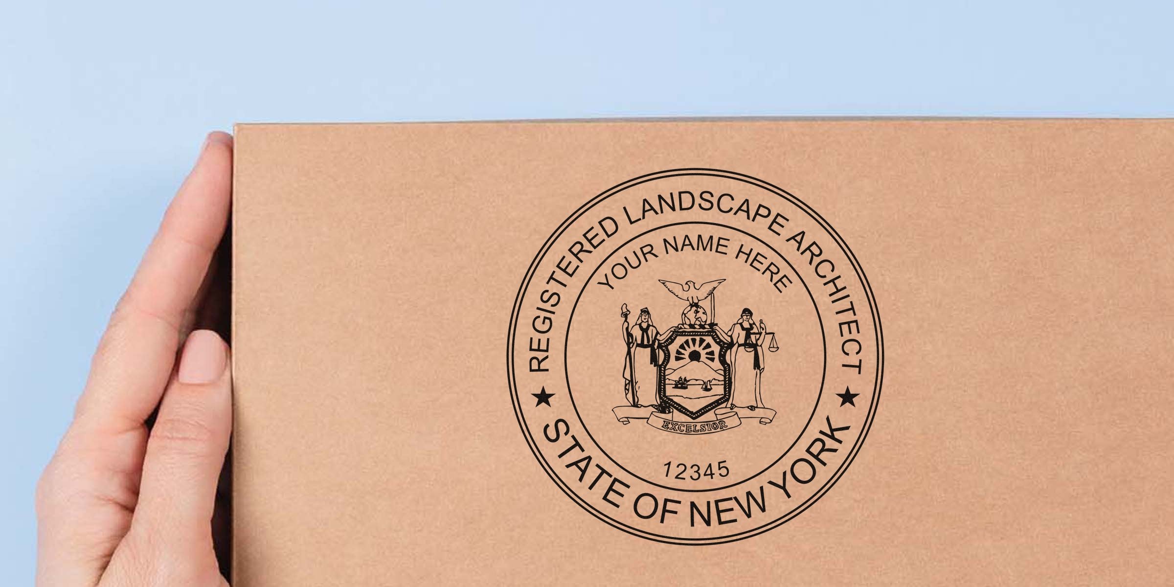 Hand holding a cardboard box stamped with New York landscape architect registration and official landscape design seals.