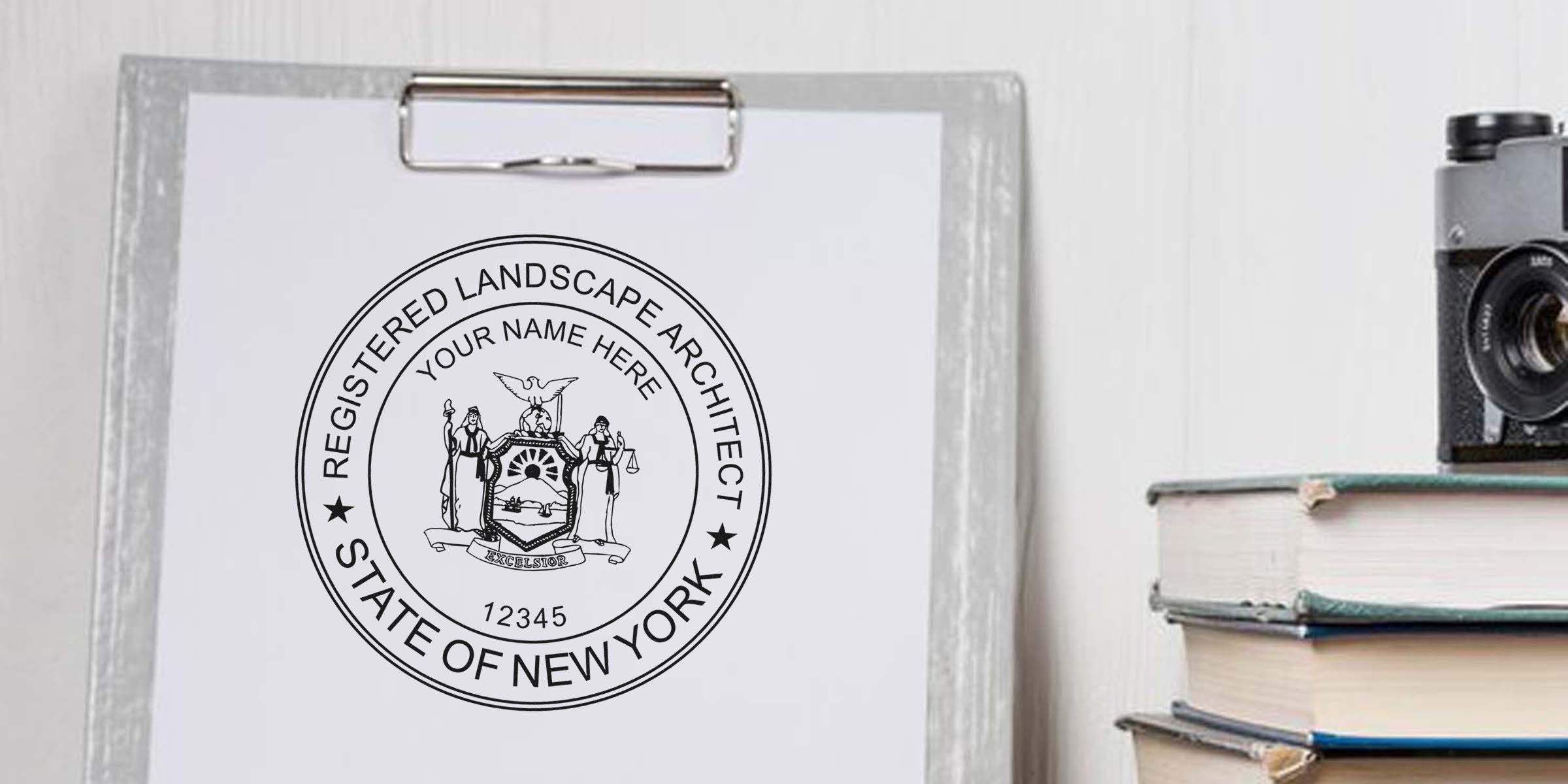 New York landscape architect's registered seal stamp on clipboard next to vintage camera and books.