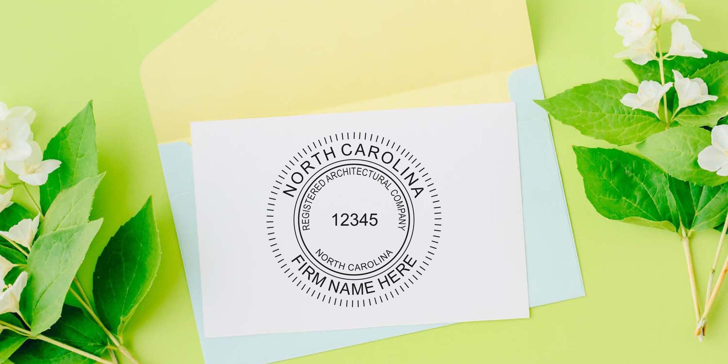 North Carolina architectural embosser seal on white card, surrounded by green leaves and pastel envelopes, showcasing the NC architectural company seal and seals.