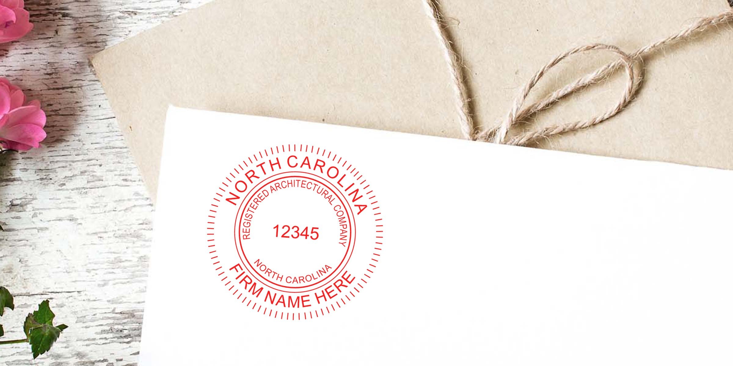 Envelope sealed with a North Carolina architect’s embossed seal, decorated with twine and pink flowers.