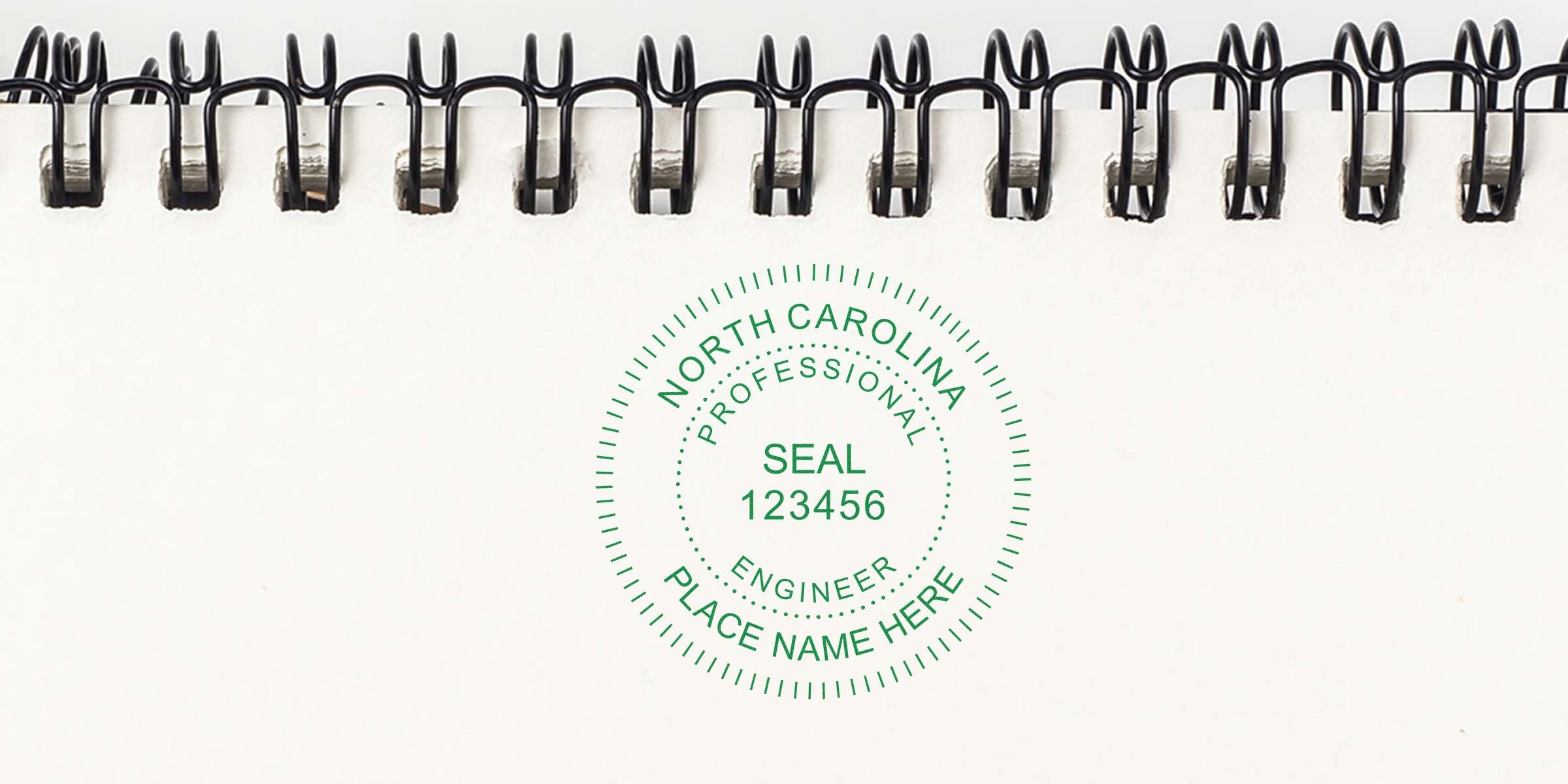 North Carolina engineer stamps with a professional engineer seal on white spiral notebook paper.