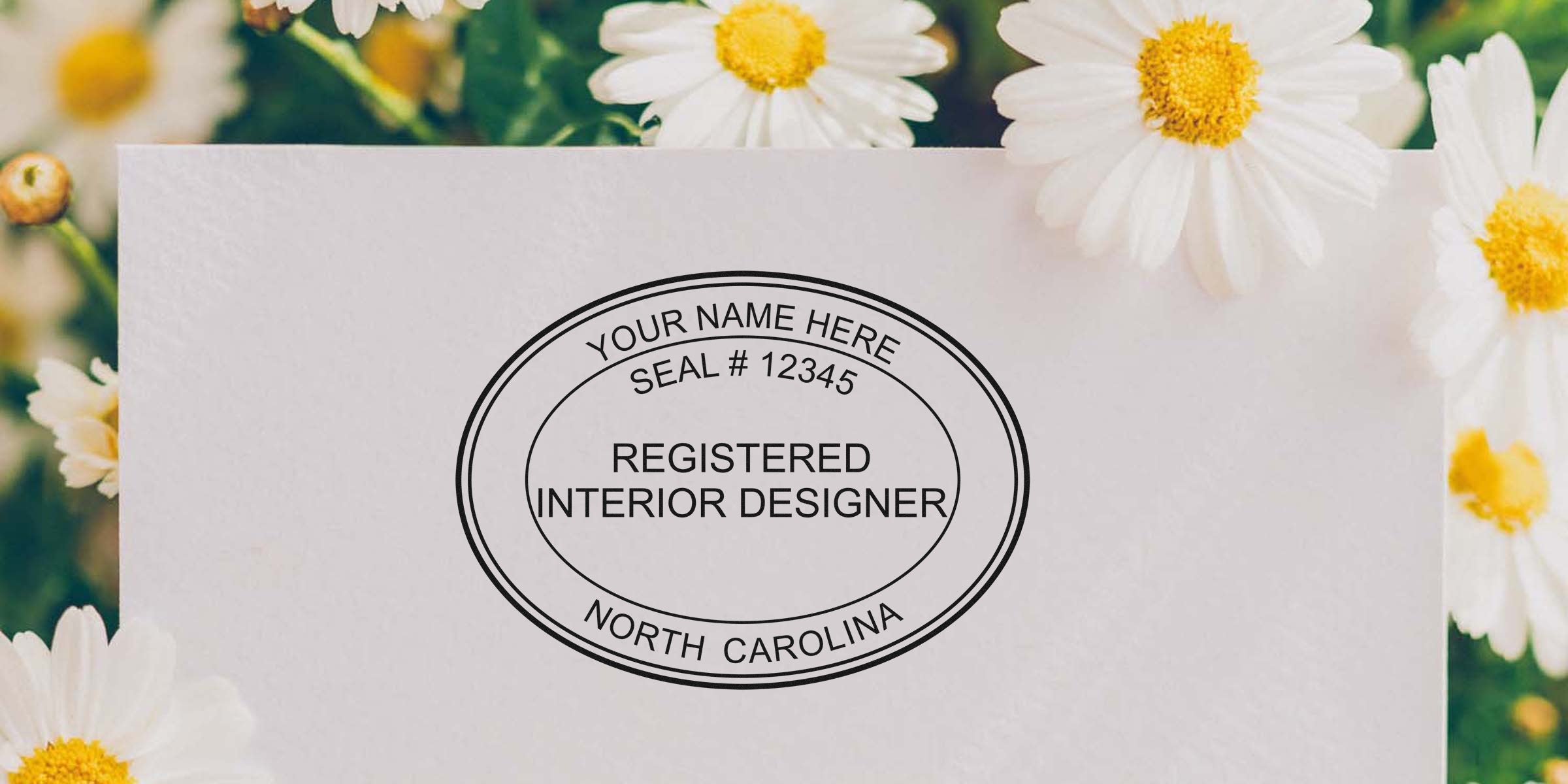 Interior designer seal stamp on white paper with daisies, showcasing North Carolina interior design rules and NC stamp requirements.