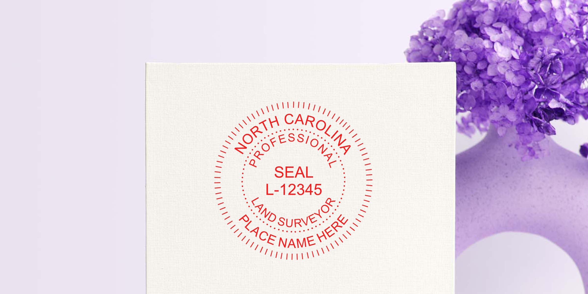 North Carolina Surveyor Seal stamp with place name and license number on white paper next to a purple flower vase, showing a Surveyor Seal Sticker.