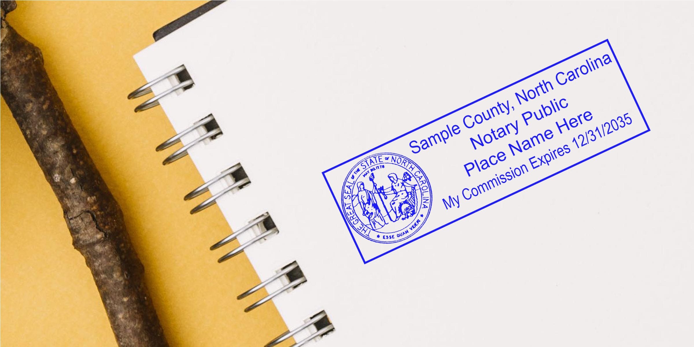 North Carolina notary seal stamped on a white spiral notebook with a wooden stick on a yellow background, symbolizing the choice of a notary seal.