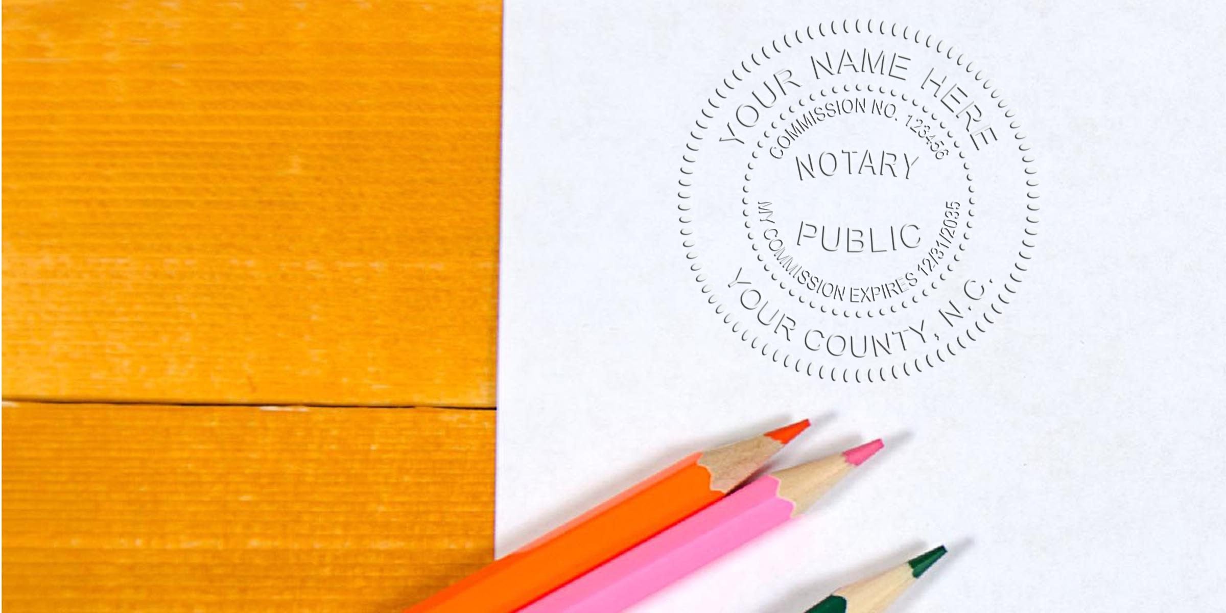 North Carolina notary seal stamped on paper with colored pencils on wooden table for document verification; purchase notary seals online.