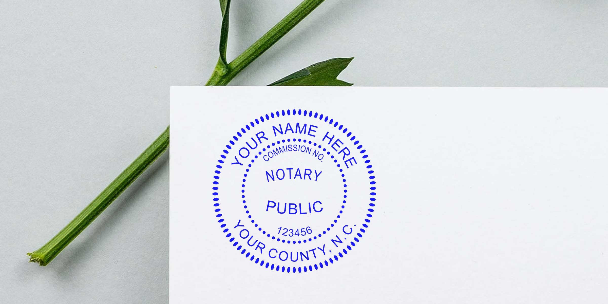 Blue North Carolina notary seal stamp on white paper with green leaf background, official NC notary seal for legal documents, personalized for certification and authentication.