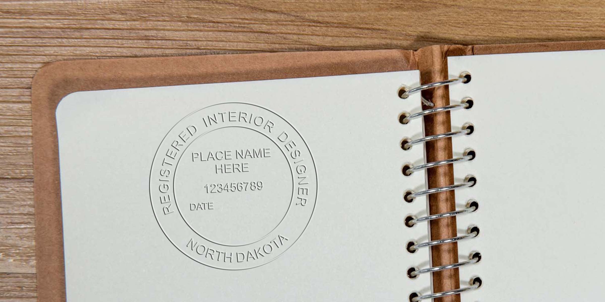 Embossing stamp of a North Dakota interior designer on a notebook page with an interior design imprint.