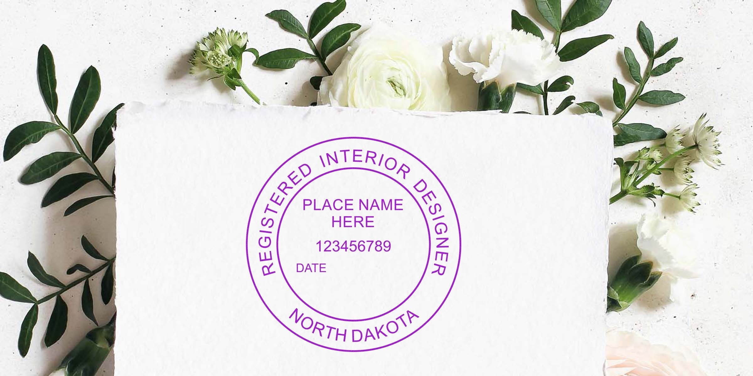 North Dakota registered interior designer stamp on white paper, framed by green leaves and white flowers, showcasing ND interior design and modern stamp design trends.