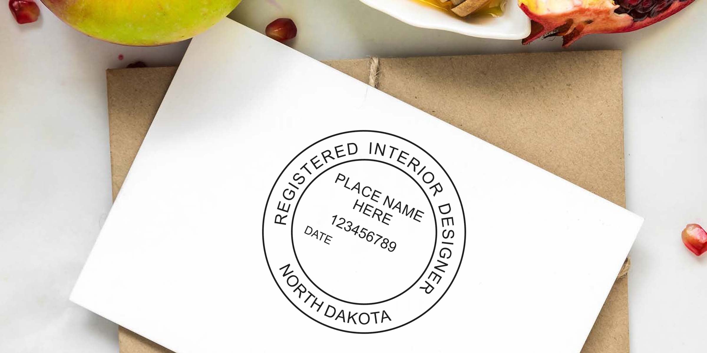 Registered interior designer stamp on envelope with apple and pomegranate seeds background, showcasing North Dakota interior design and online shopping tips.