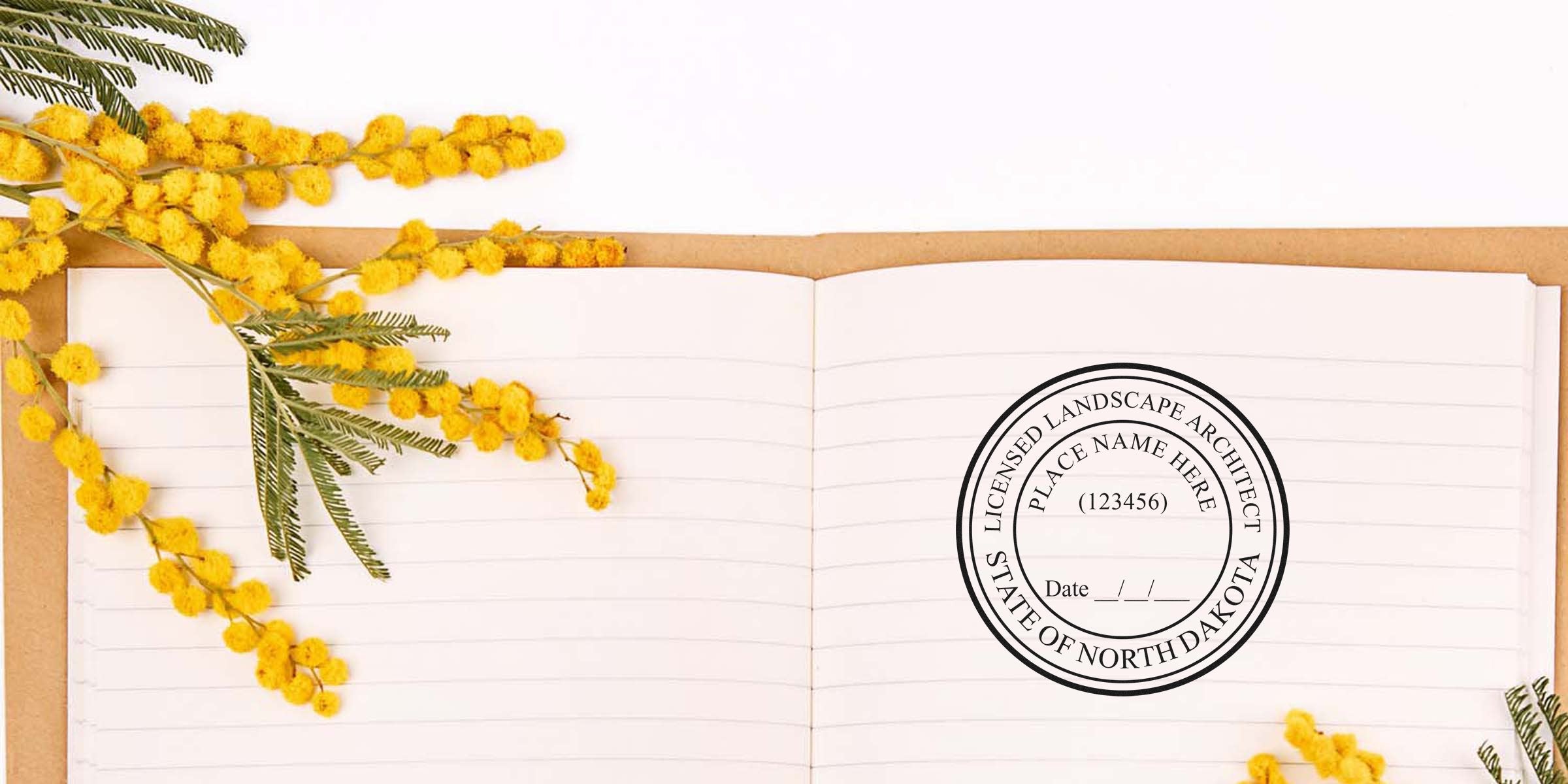Open notebook with yellow mimosa flowers, North Dakota landscape architect seal, and project requirements.
