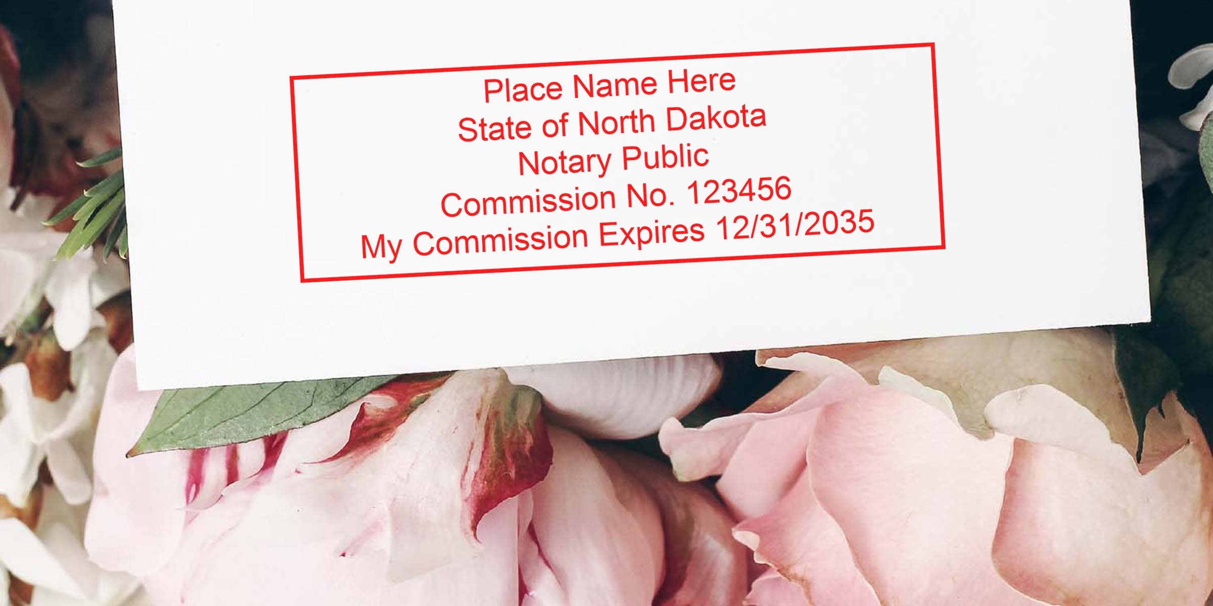 North Dakota notary public commission stamp on white paper with pink flowers, showcasing top notary supplies from a complete North Dakota notary kit.