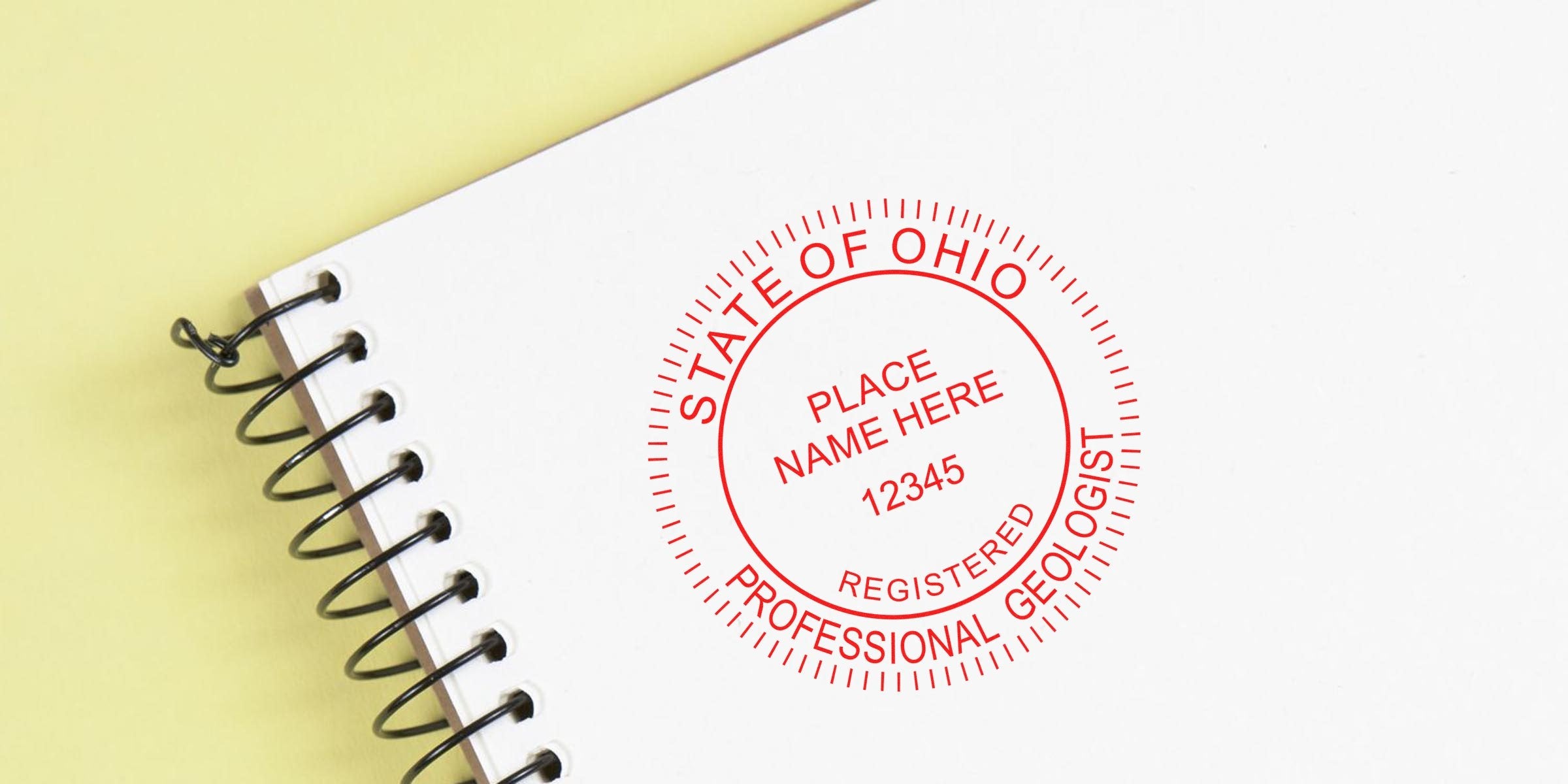 Ohio Professional Geologist Seal stamped on white spiral notebook for Geologist Certification in Ohio.