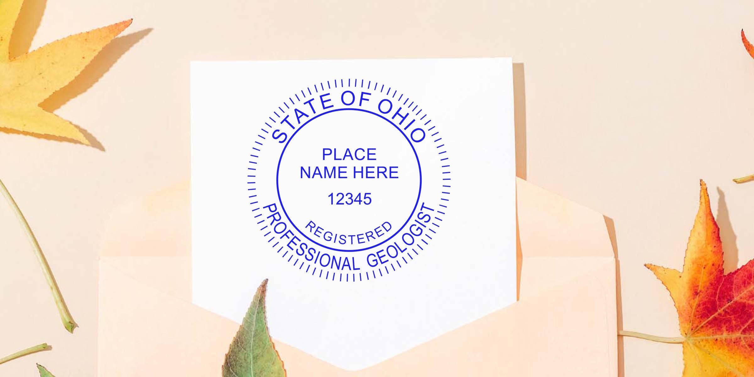 Ohio Professional Geologist Stamp and Ohio Geologist License on white paper, framed by autumn leaves and an envelope.