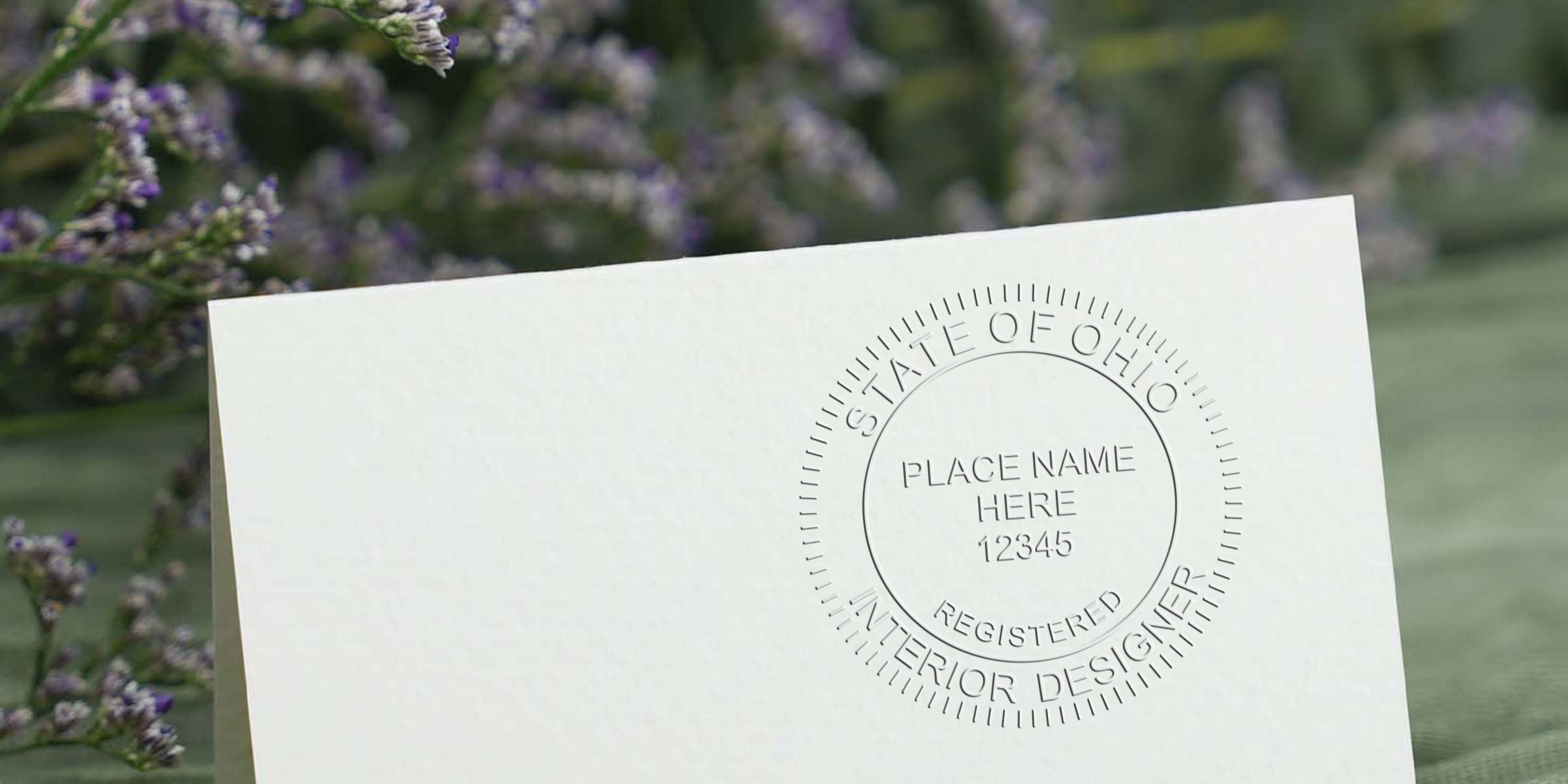 Embossed Ohio interior designer seal on white card with lavender flower background, highlighting stamp design tips.