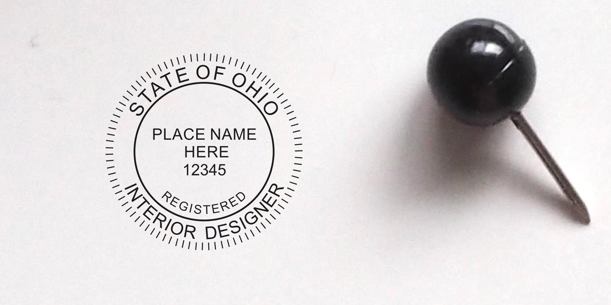 Ohio Interior Designer Seal with black push pin on white background, symbolizing Ohio interior design regulations.