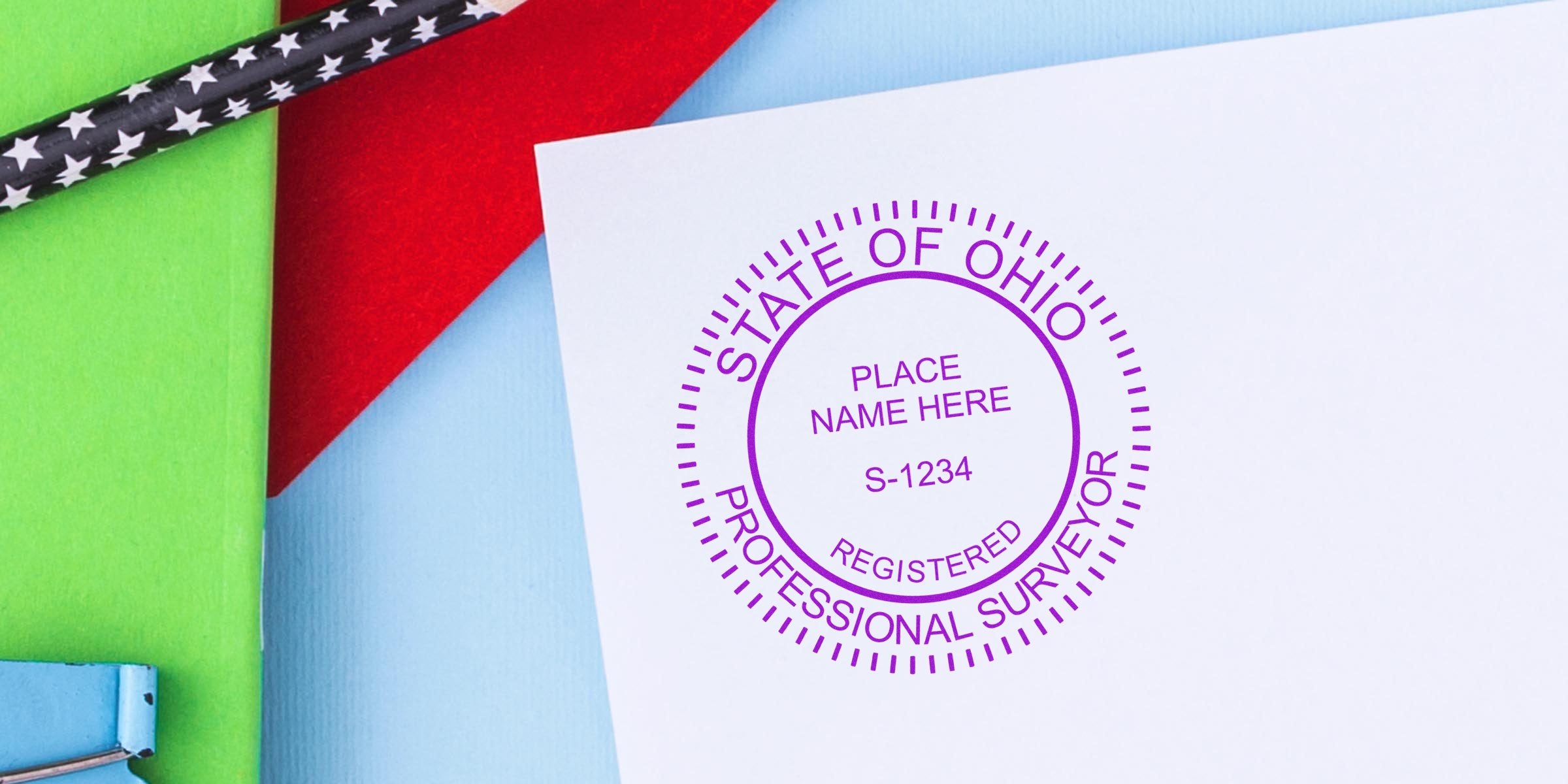 Ohio professional surveyor stamp on white paper, surrounded by colorful background and black star-patterned pencils, showcasing Ohio and self-inking surveyor stamps.