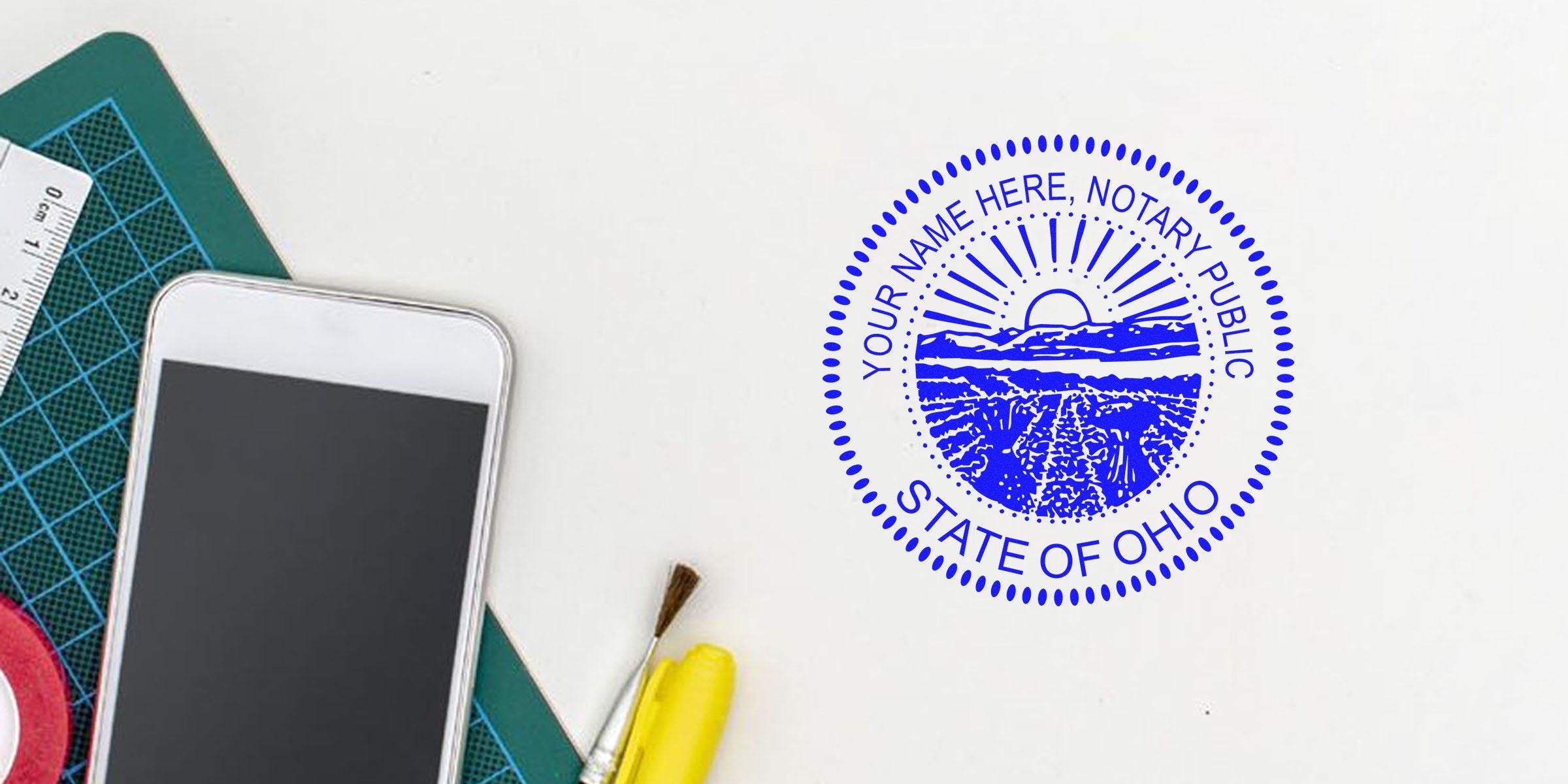 Ohio notary public stamp on white paper, surrounded by affordable OH notary and office supplies, with a smartphone nearby.