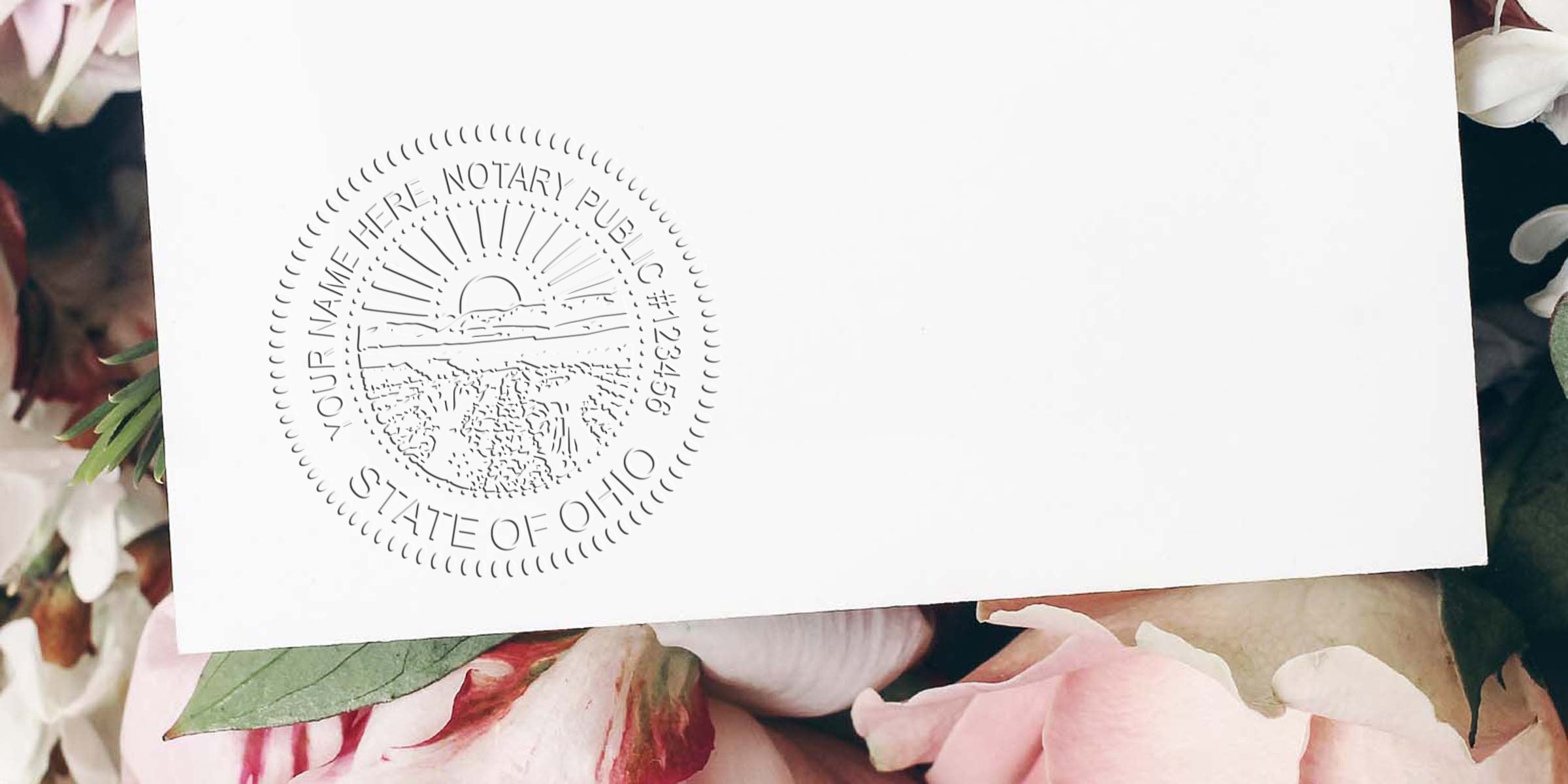 Ohio notary public embossed seal on white paper with pink flowers, showing Ohio notary stamp law and regulations.