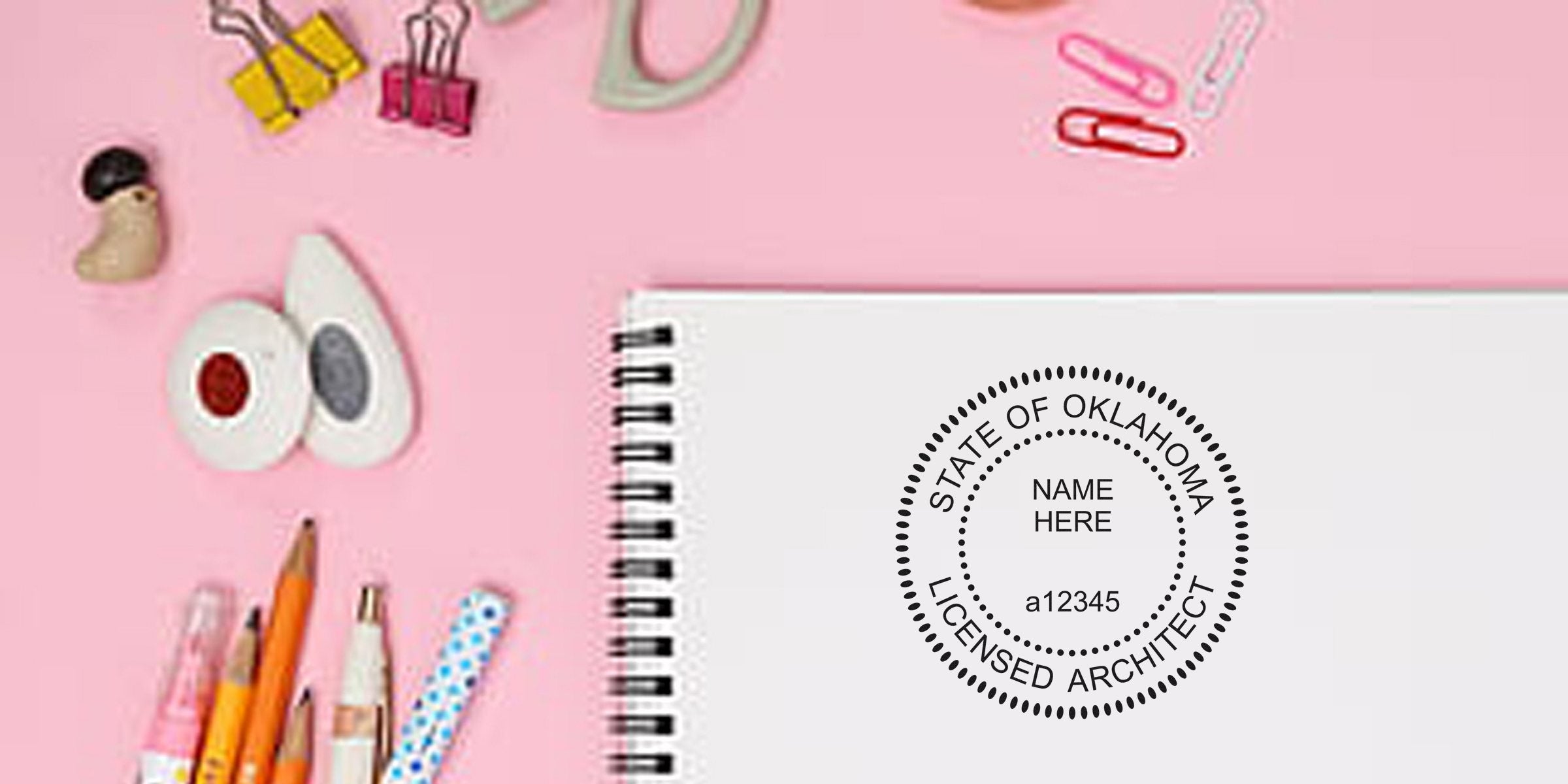 Oklahoma Architectural Embossing Stamp on notebook with office supplies on pink background, highlighting stamp details.