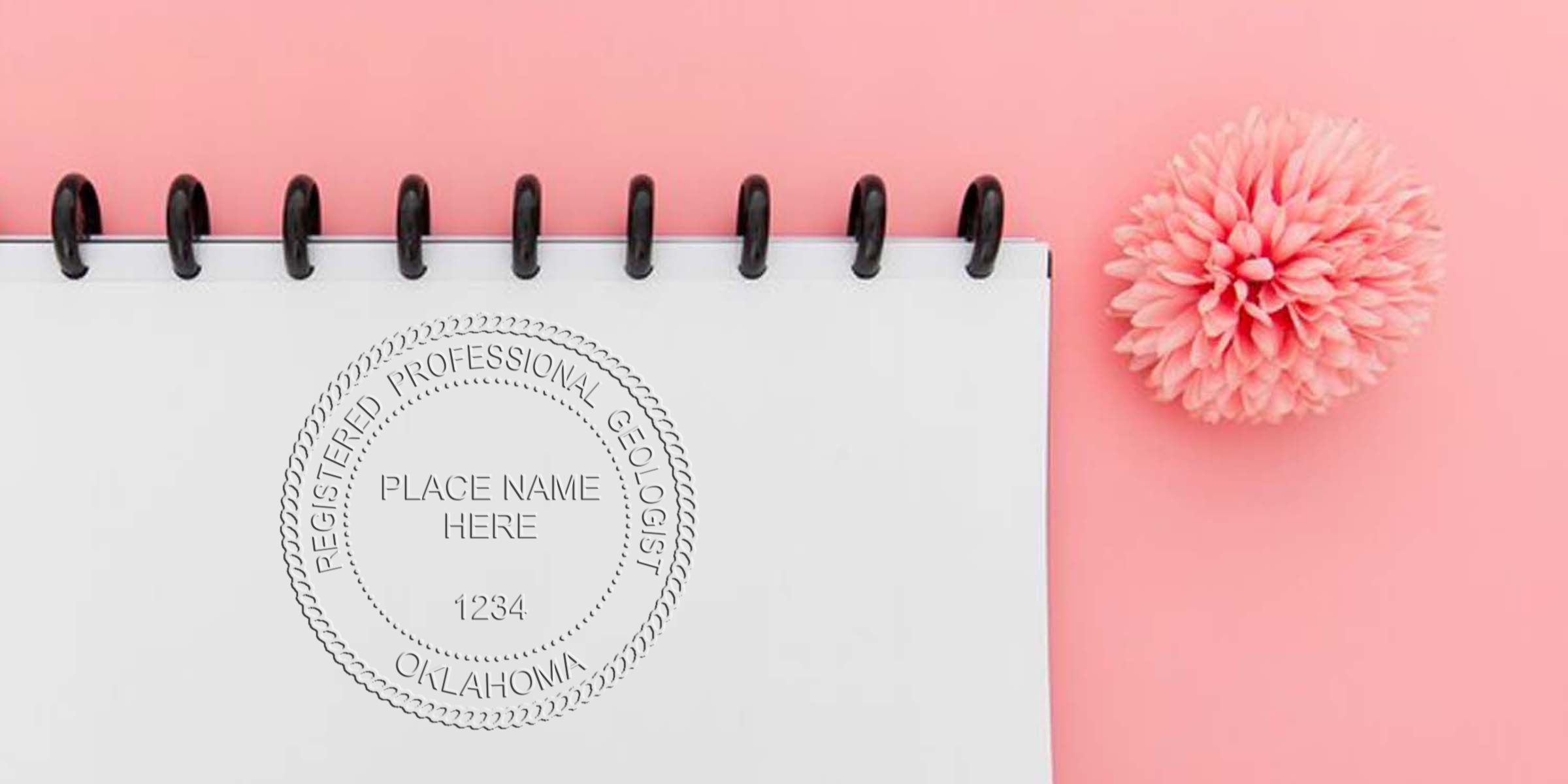 Oklahoma Geologist Seal embossed on white notebook with pink flower background, showing Registered Professional Geologist seal stamp.