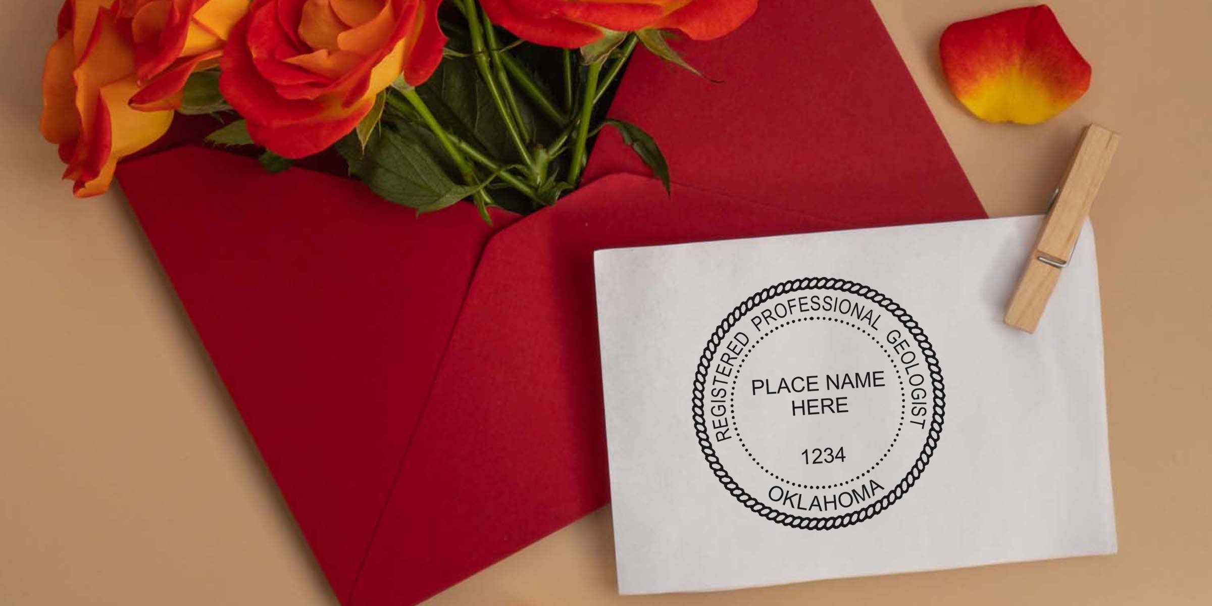 Red envelope with orange roses and an Oklahoma Geologist stamp on white paper, symbolizing growth and success in a geology career.