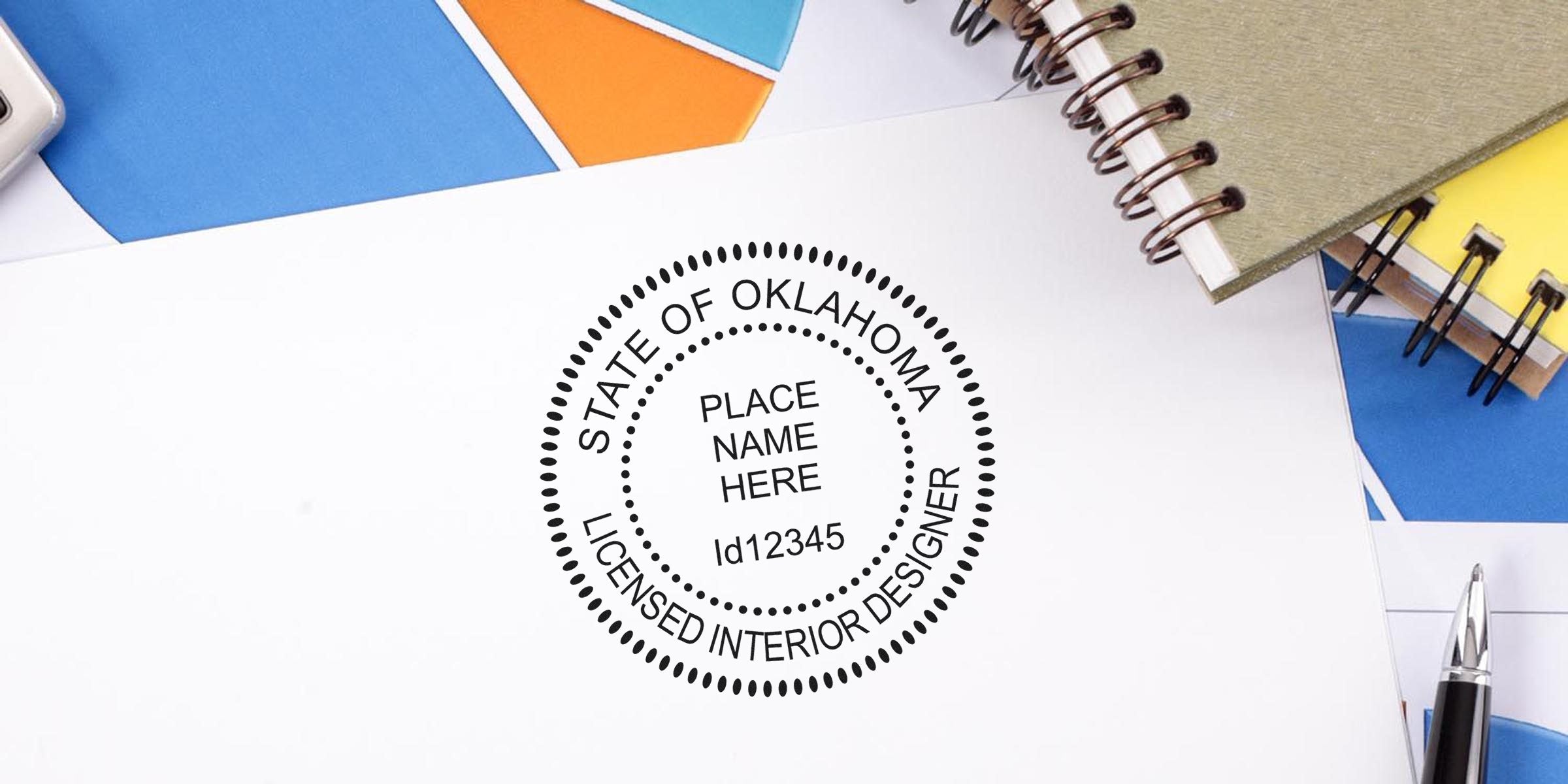 Oklahoma licensed interior designer stamp on white paper with office supplies, showing Oklahoma interior designer seal and certification.