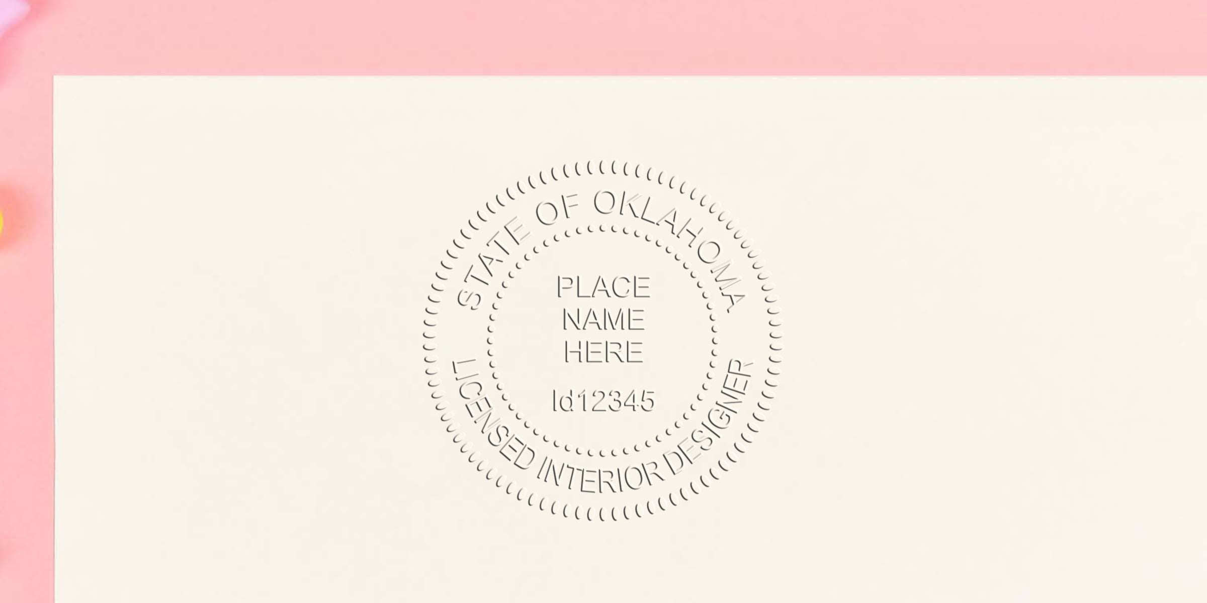 Oklahoma interior designer embossed seal on white paper with pink background, showing the Oklahoma interior designer stamp and tips for purchasing interior design stamps.