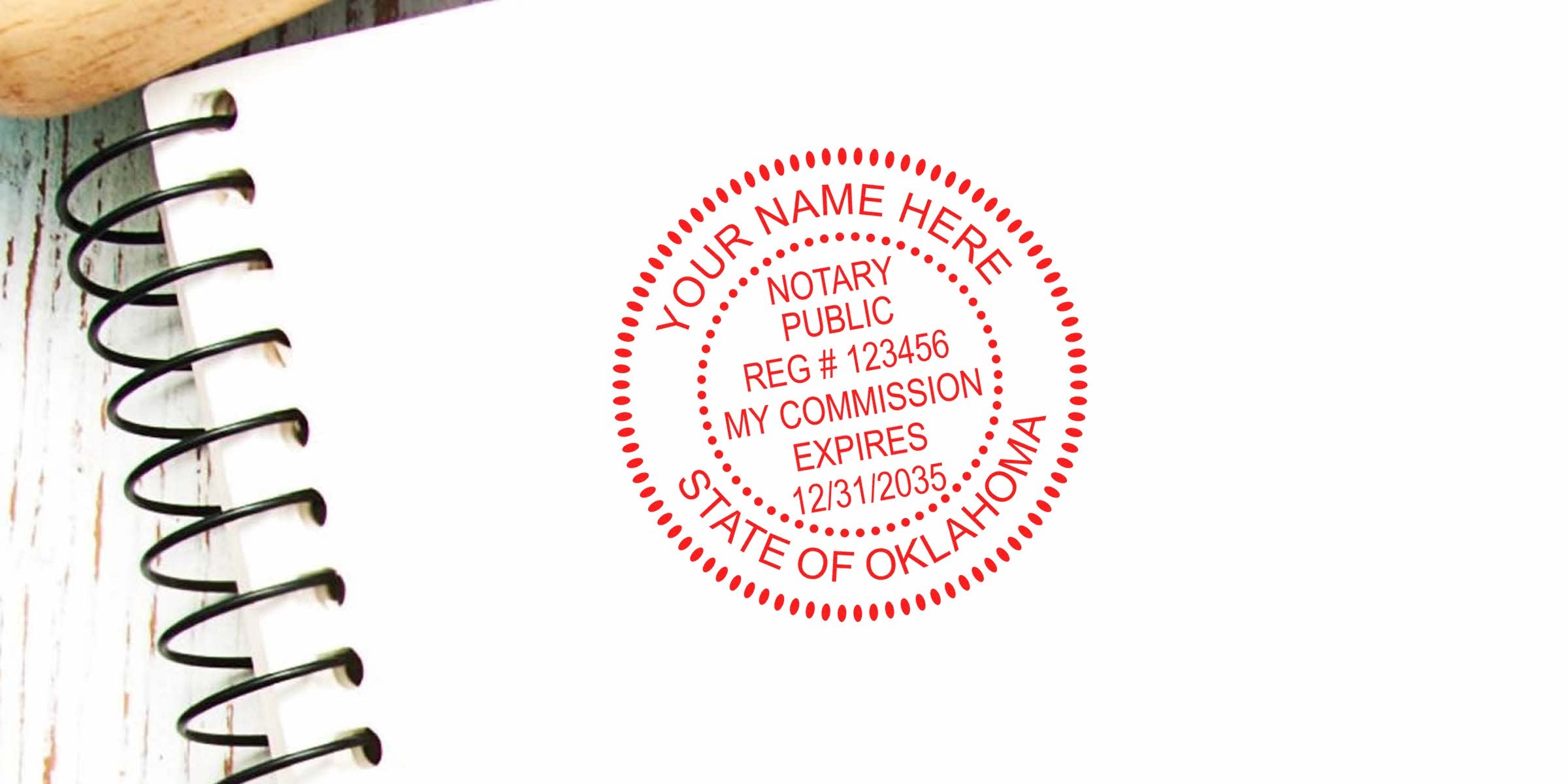 Oklahoma notary seal and stamp on white paper with commission expiration date next to a spiral notebook.