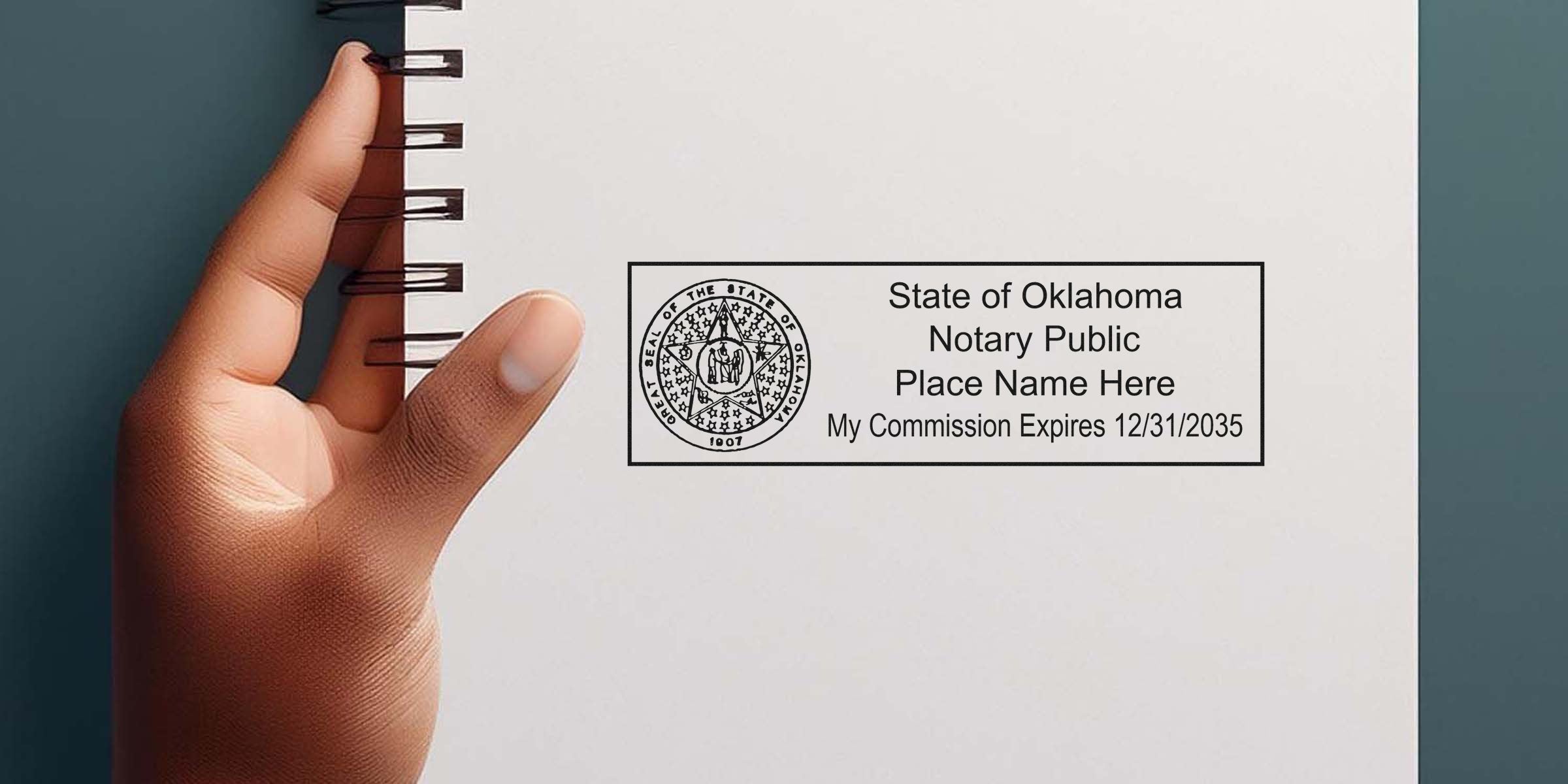 Hand holding white paper with Oklahoma notary public stamp showing commission expiration date, highlighting Oklahoma notary seal size and dimensions.